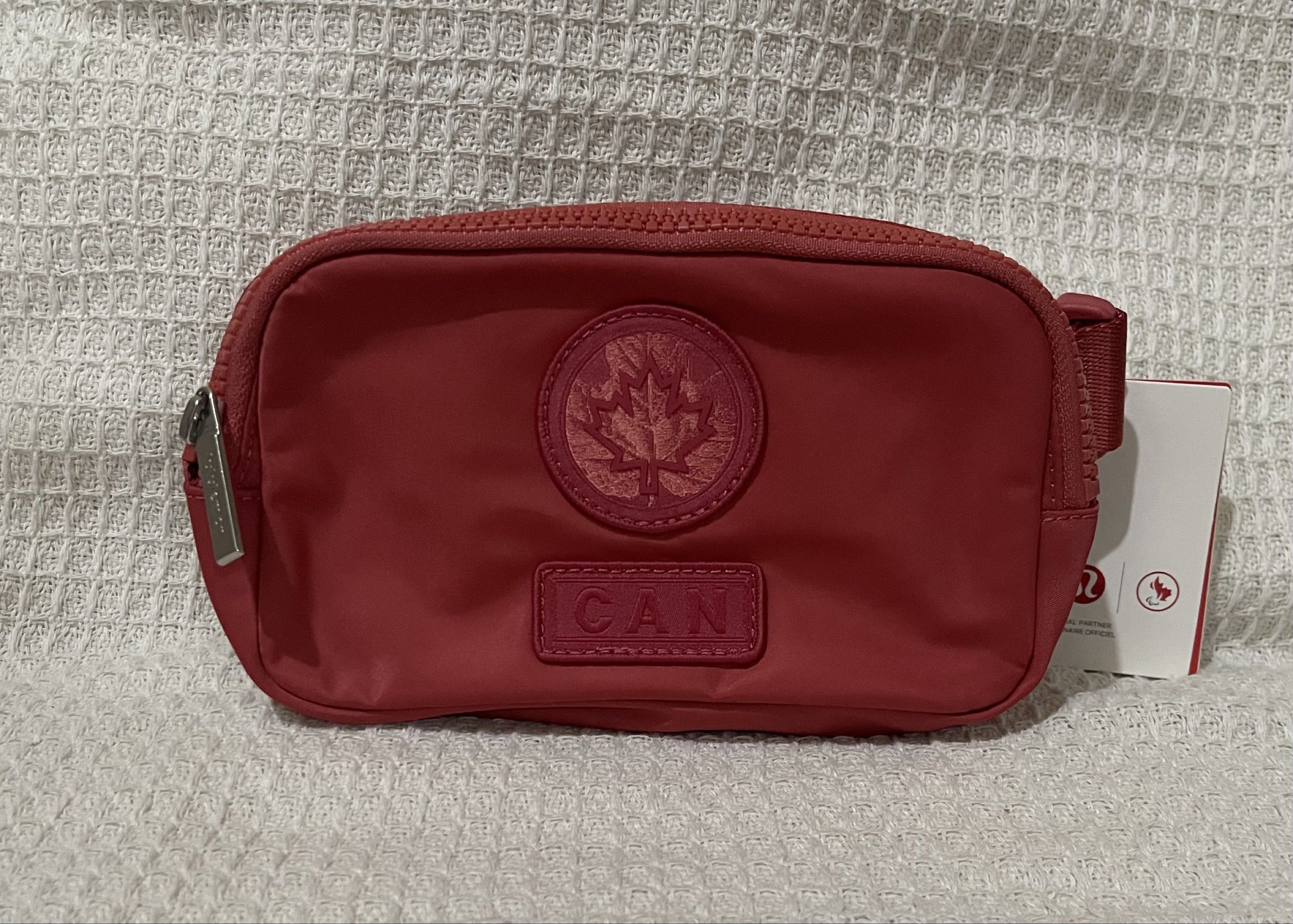 Lululemon Everywhere Belt Bag - Red (Category: Cross-body Bags) located in Bulacan. Submitted by prefinds (Listing ID 1419598610, Image 2). Description: - Lululemon Everywhere Belt Bag - Vibrant red color - Main compartment - Interior pocket - Adjustable strap - Zipper closure - Front emblem with maple leaf design and "CAN" 3pcs Available Bought from Canada.
