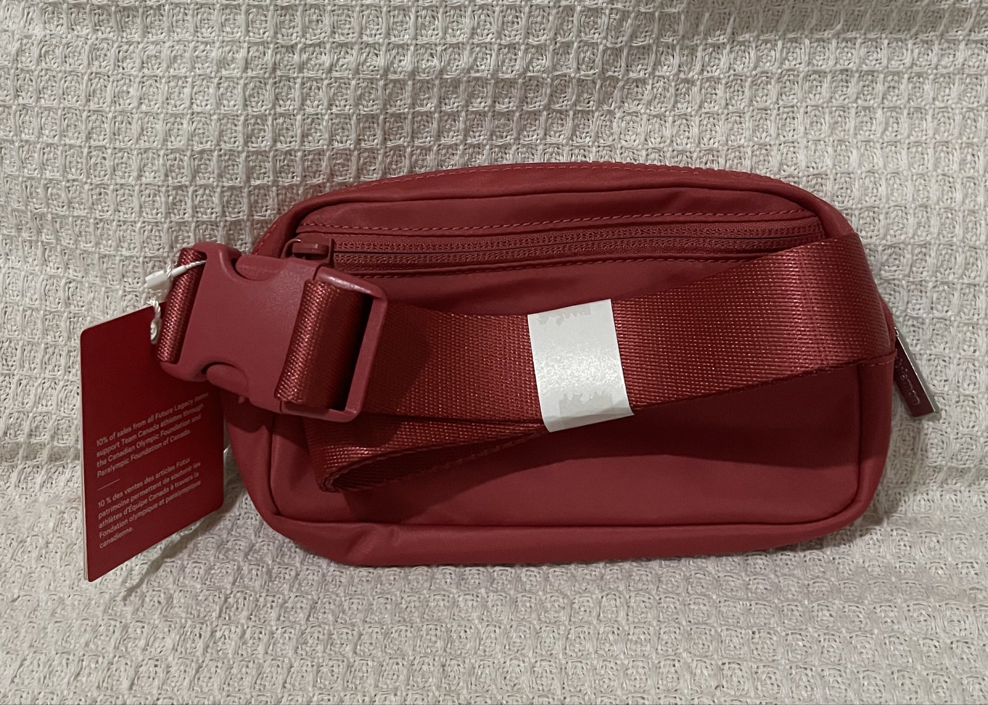 Lululemon Everywhere Belt Bag - Red (Category: Cross-body Bags) located in Bulacan. Submitted by prefinds (Listing ID 1419598610, Image 3). Description: - Lululemon Everywhere Belt Bag - Vibrant red color - Main compartment - Interior pocket - Adjustable strap - Zipper closure - Front emblem with maple leaf design and "CAN" 3pcs Available Bought from Canada.