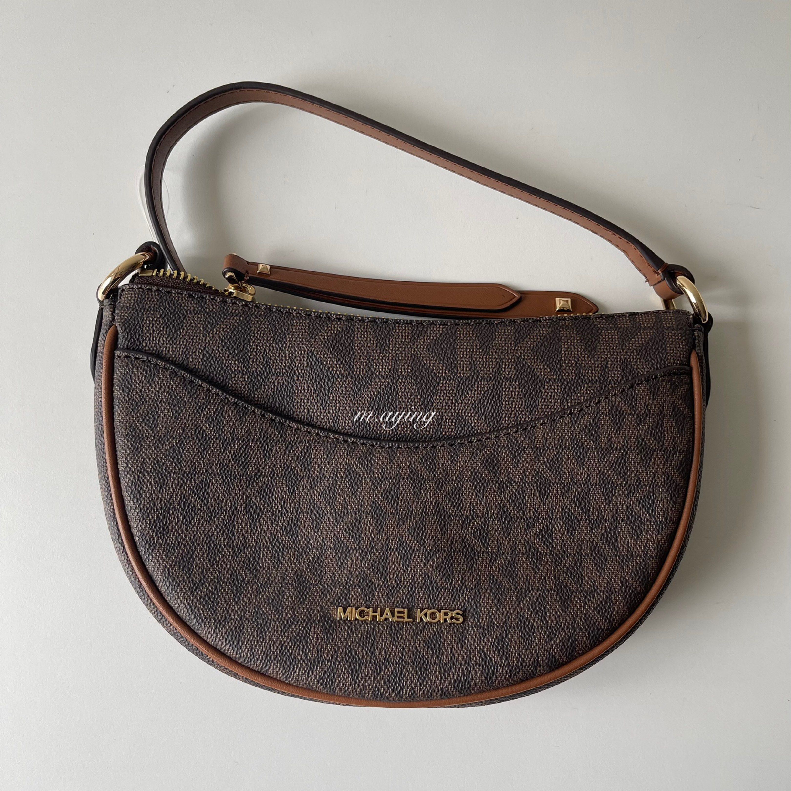 Michael Kors Dover Crossbody Bag (Category: Luxury Bags & Wallets) located in Mandaluyong City. Submitted by momandbabystuffph (Listing ID 1419629926, Image 1). Description: - Michael Kors crossbody bag - Brown signature print - Half-moon shape - Main compartment with zipper closure - Interior pocket - Michael Kors logo on front - Includes original price tag.