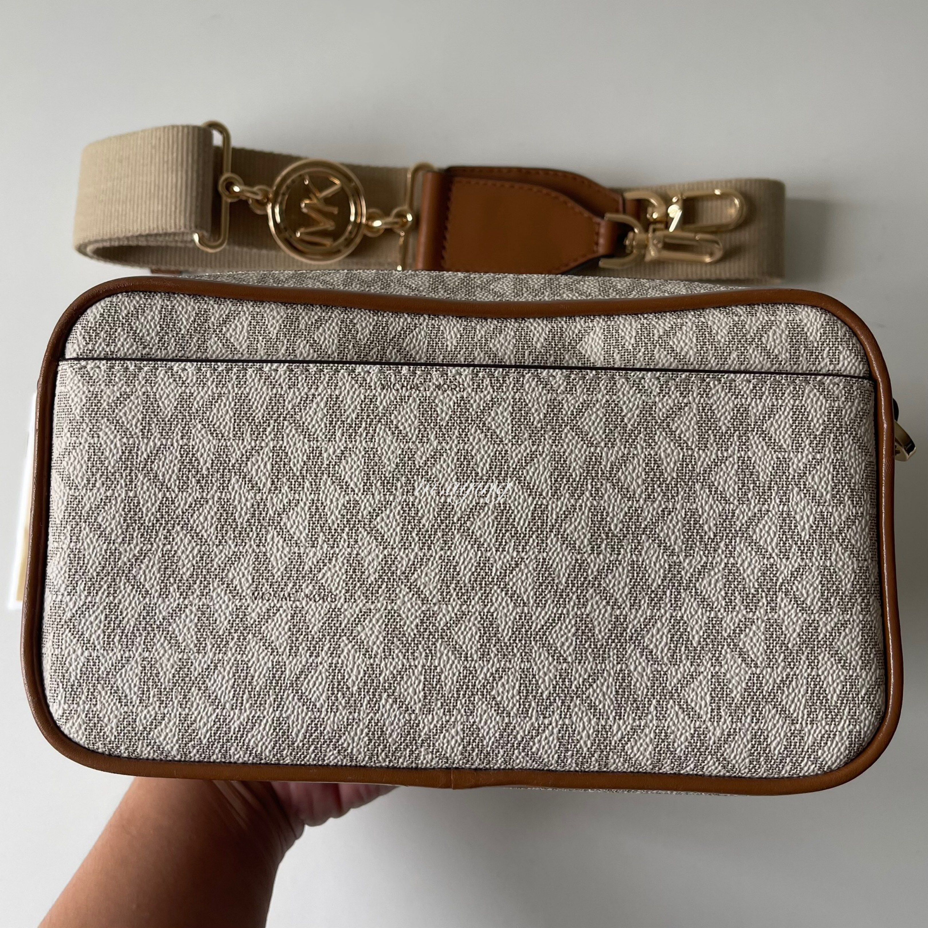 Michael Kors Jet Set Bradshaw Camera Bag (Category: Luxury Bags & Wallets) located in Mandaluyong City. Submitted by momandbabystuffph (Listing ID 1419629924, Image 3). Description: - Michael Kors crossbody bag - Signature MK logo print - Detachable and adjustable shoulder strap - Flap closure with gold-tone lock - Interior zippered pocket - Includes care card - Gold-tone hardware - Brown trim.