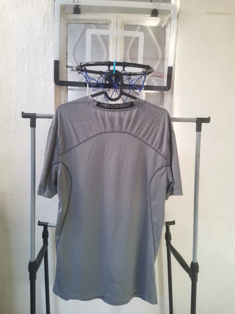 Nike Pro Combat Gray Shirt compression (Category: Activewear) located in Baliuag. Submitted by rjpagaduan (Listing ID 1419721013, Image 2). Description: - Gray Nike Pro Combat shirt - Nike logo on chest - Pro Combat branding on collar - Crew neck and short sleeves - Minor flaw: small hole on the side - Made with breathable material.