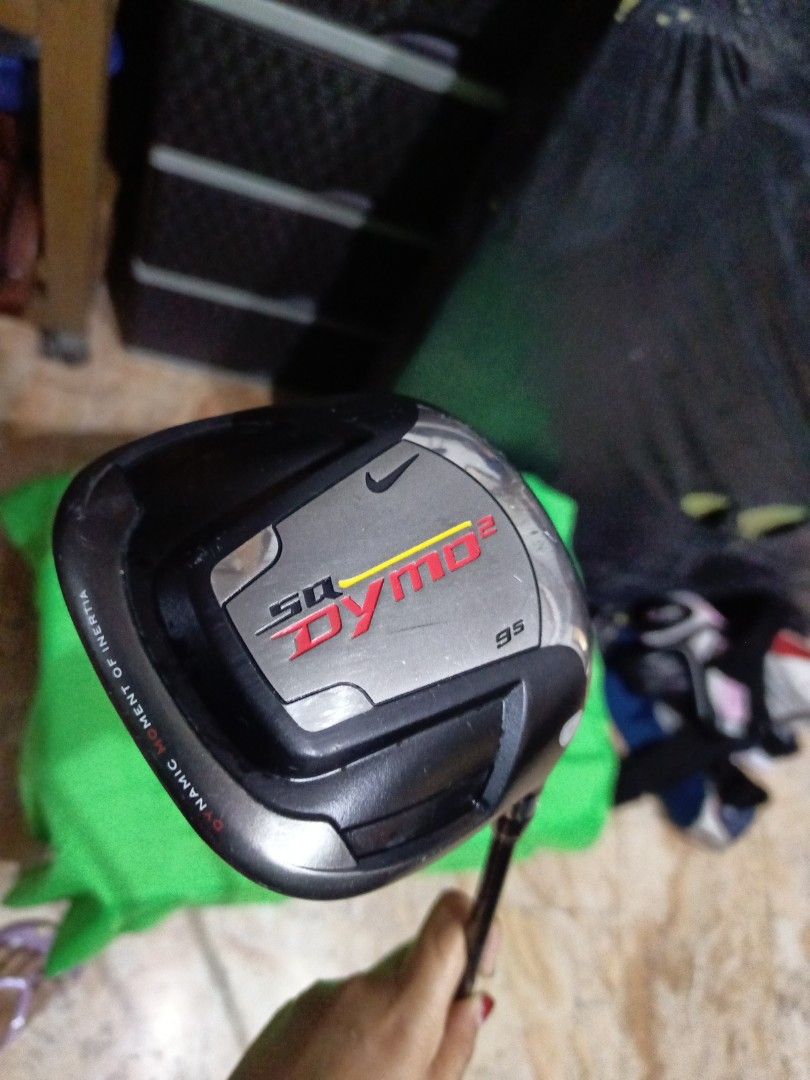 Nike SQ Dymo2 9.5 Driver (Category: Golf) located in Manila. Submitted by yeonmei5614747 (Listing ID 1419641268, Image 1). Description: - Nike SQ Dymo2 9.5 driver - Features a black and silver club head - Nike logo on the club head - Black and yellow shaft - Square-shaped club head - Black grip - Designed for golf.