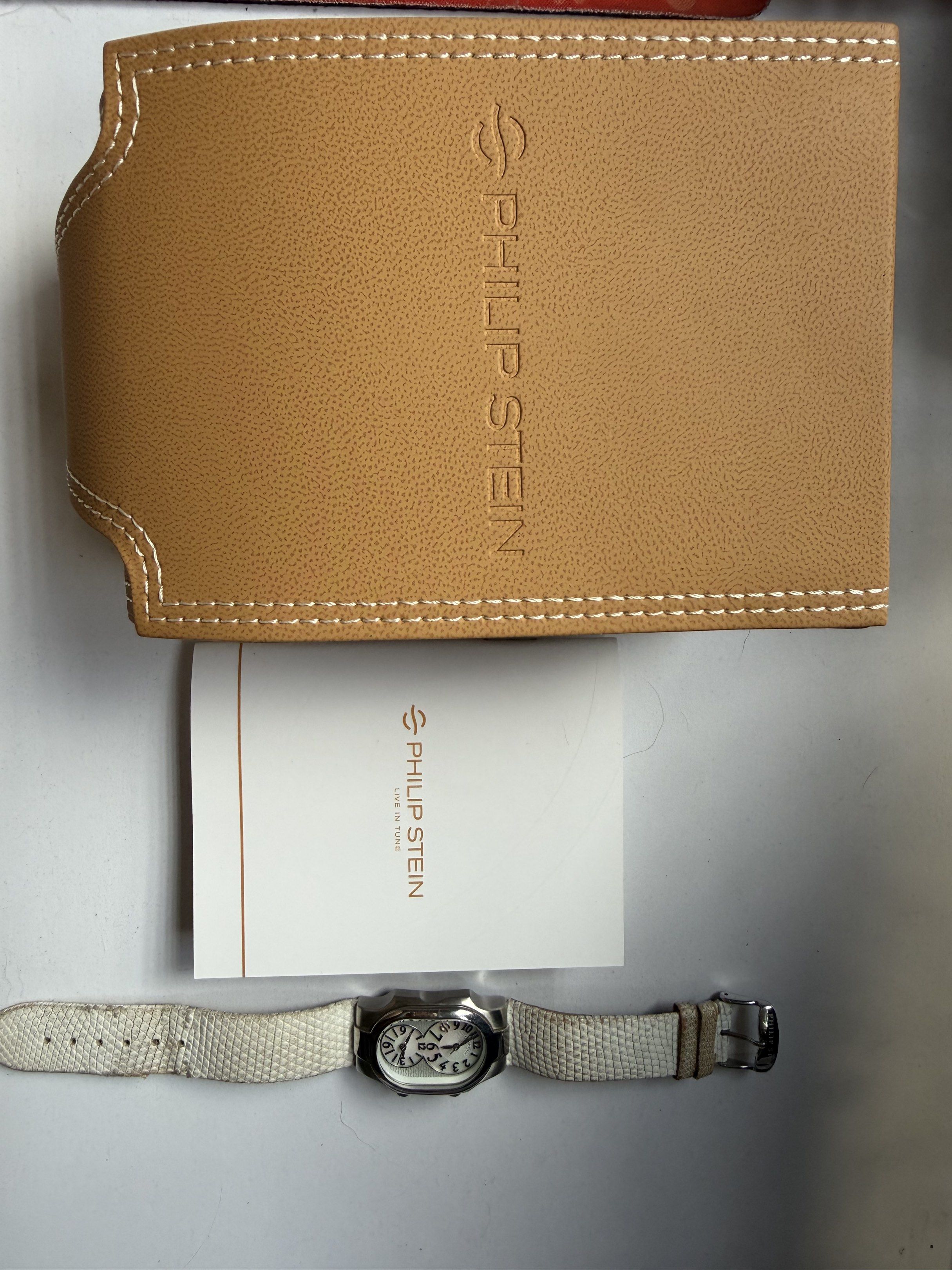 Philip Stein Dual Time Zone Watch in white lizard (Category: Luxury Watches) located in Quezon City. Submitted by antheia89 (Listing ID 1419654640, Image 2). Description: - Philip Stein watch - Dual time zone display - White strap with textured pattern - Stainless steel case - White dial - Includes original box and documentation - Branded clasp.