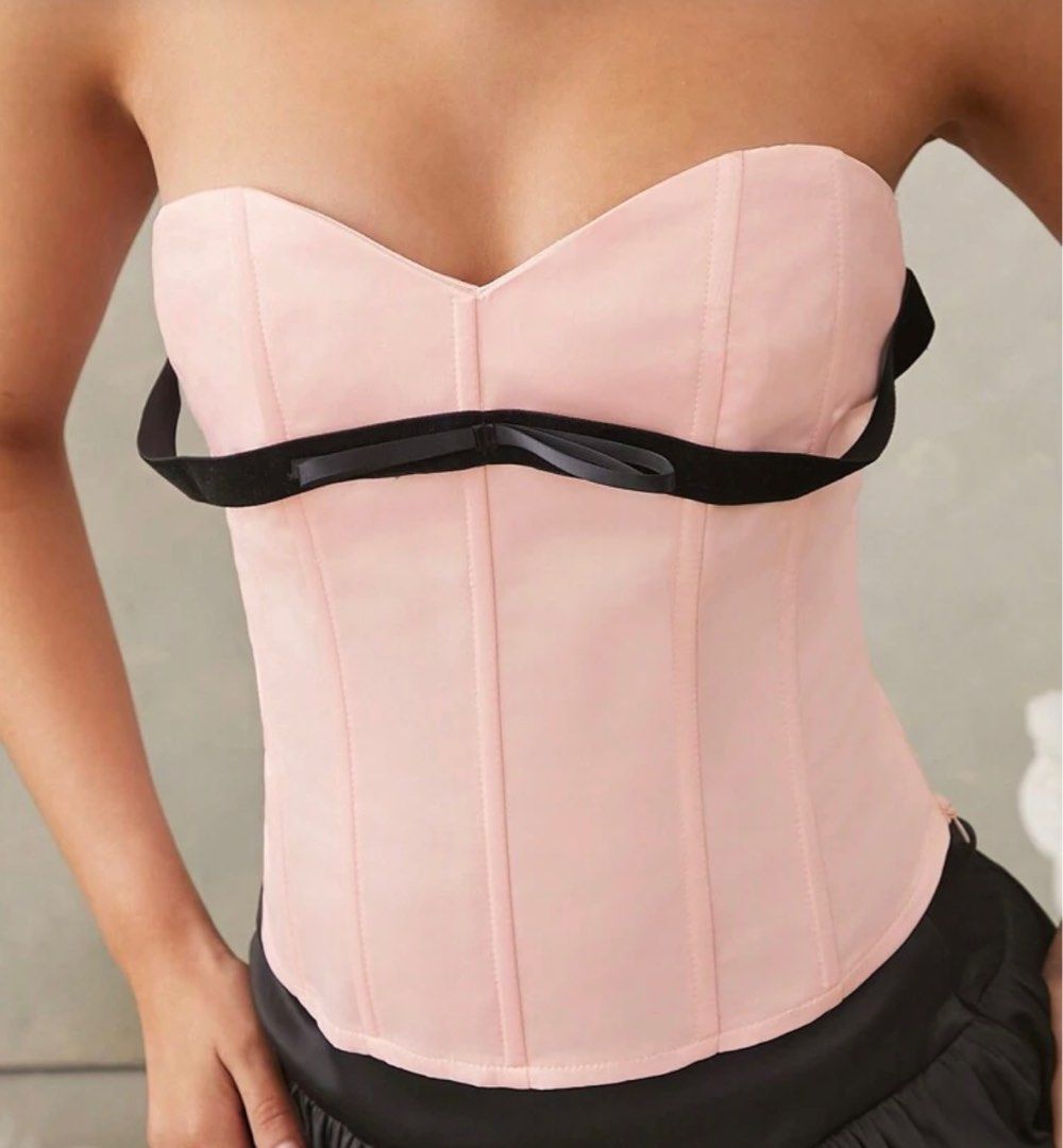 Pink Corset Top with Black Bow (Category: Sleeveless) located in Baguio. Submitted by flarelle (Listing ID 1419750706, Image 2). Description: - Only Used Once (sa concert lang po ng BP) - Soft pink corset top - Sweetheart neckline - Black bow detail - Structured fit - Strapless design - Smooth fabric - Versatile styling options.