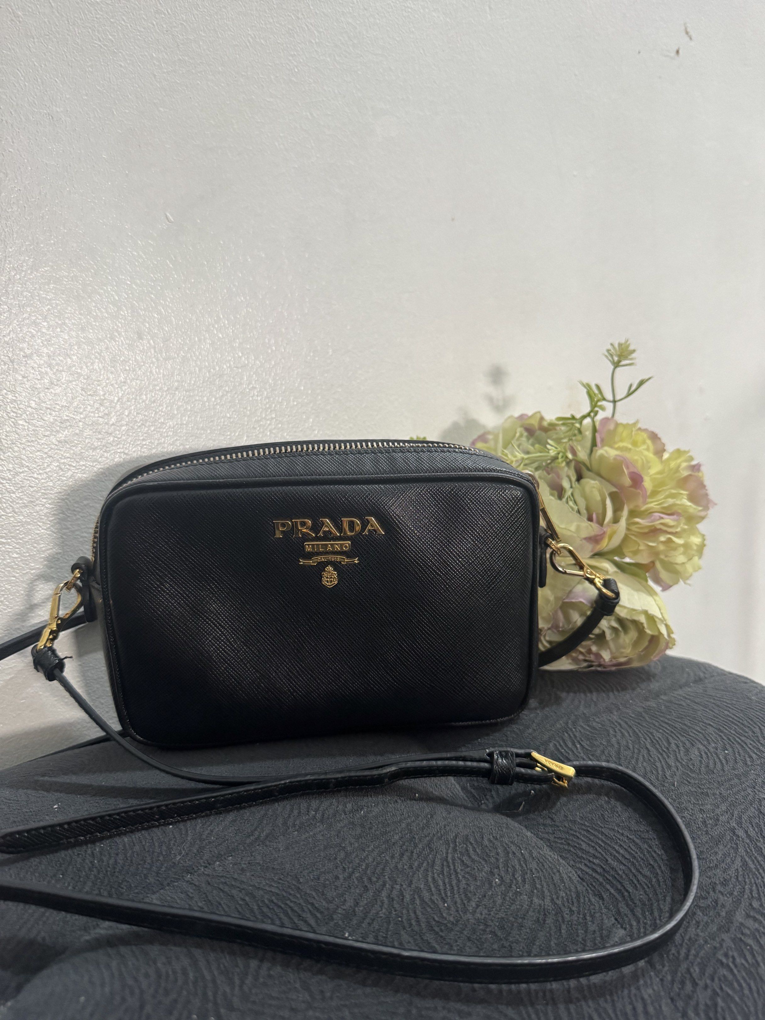 Prada Crossbody Bag (Category: Luxury Bags & Wallets) located in Manila. Submitted by missgrace_collection (Listing ID 1419594928, Image 1). Description: - Authentic Prada crossbody bag - Black color with card - Gold-tone hardware may signs of used po yung strap pls see photo.