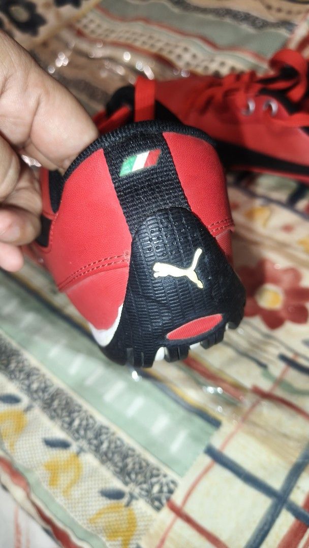 Puma Ferrari Red Sneakers (Category: Sneakers) located in Tanza. Submitted by declutterolshoppe (Listing ID 1419688884, Image 2). Description: - Puma Ferrari sneakers - Red and black color scheme - Ferrari logo on the side - Puma logo on the heel - Black soles with white accents - Red laces - Padded interior for comfort - Size indicated inside the shoe.