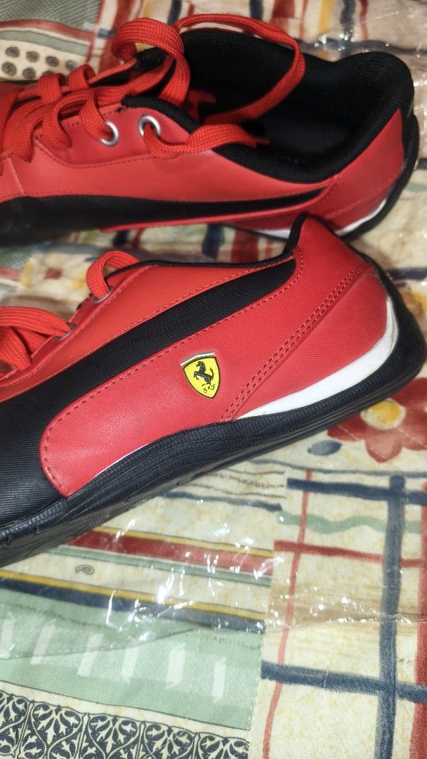 Puma Ferrari Red Sneakers (Category: Sneakers) located in Tanza. Submitted by declutterolshoppe (Listing ID 1419688884, Image 3). Description: - Puma Ferrari sneakers - Red and black color scheme - Ferrari logo on the side - Puma logo on the heel - Black soles with white accents - Red laces - Padded interior for comfort - Size indicated inside the shoe.