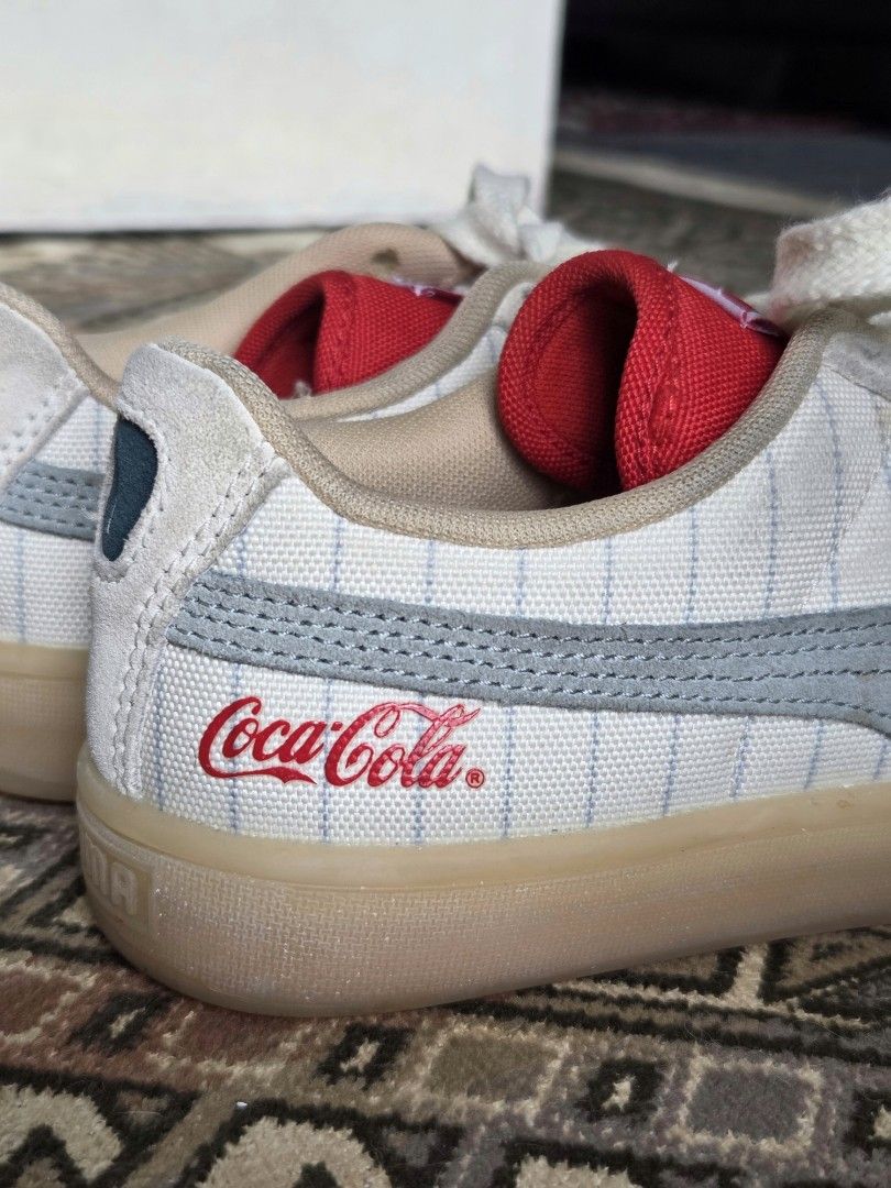 Puma x Coca-Cola Sneakers (Category: Sneakers) located in Manila. Submitted by didst (Listing ID 1419602599, Image 3). Description: - Puma x Coca-Cola collaboration sneakers - Color scheme: White and light blue - Features the Coca-Cola logo - Design: Low-top - Interior: Red - Sole: Light brown - Laces: White.