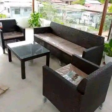 Rattan Outdoor Sofa Set with Glass Table (Category: Outdoor Furniture) located in Manila. Submitted by money-lyn (Listing ID 1419701851, Image 3). Description: Stylish rattan outdoor furniture set. Includes a two-seater sofa, two armchairs, and a coffee table with a glass top. The set features comfortable cushions and a dark brown woven design. Perfect for patios, balconies, or gardens. Provides a comfortable and inviting space for relaxation and