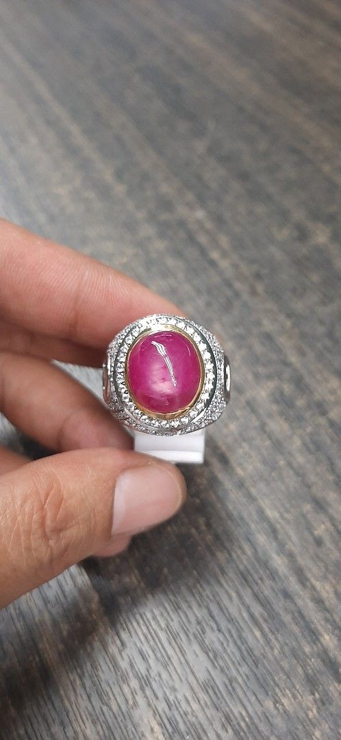 Ruby Gemstone Ring (Category: Rings) located in Singapore. Submitted by permataqolbu (Listing ID 1419746025, Image 1). Description: - Features a vibrant red ruby gemstone. - Silver band with intricate detailing. - Gold-colored setting..