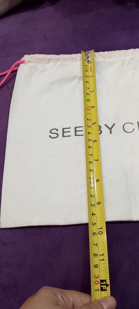 See by Chloé Dust Bag (Category: Luxury Bags & Wallets) located in Cabanatuan. Submitted by miss.maia (Listing ID 1419761008, Image 3). Description: - Authentic See by Chloé dust bag - White fabric - Black brand logo - Drawstring closure with pink cords - Approximately 11 inches in length - Perfect for protecting your See by Chloé bag.