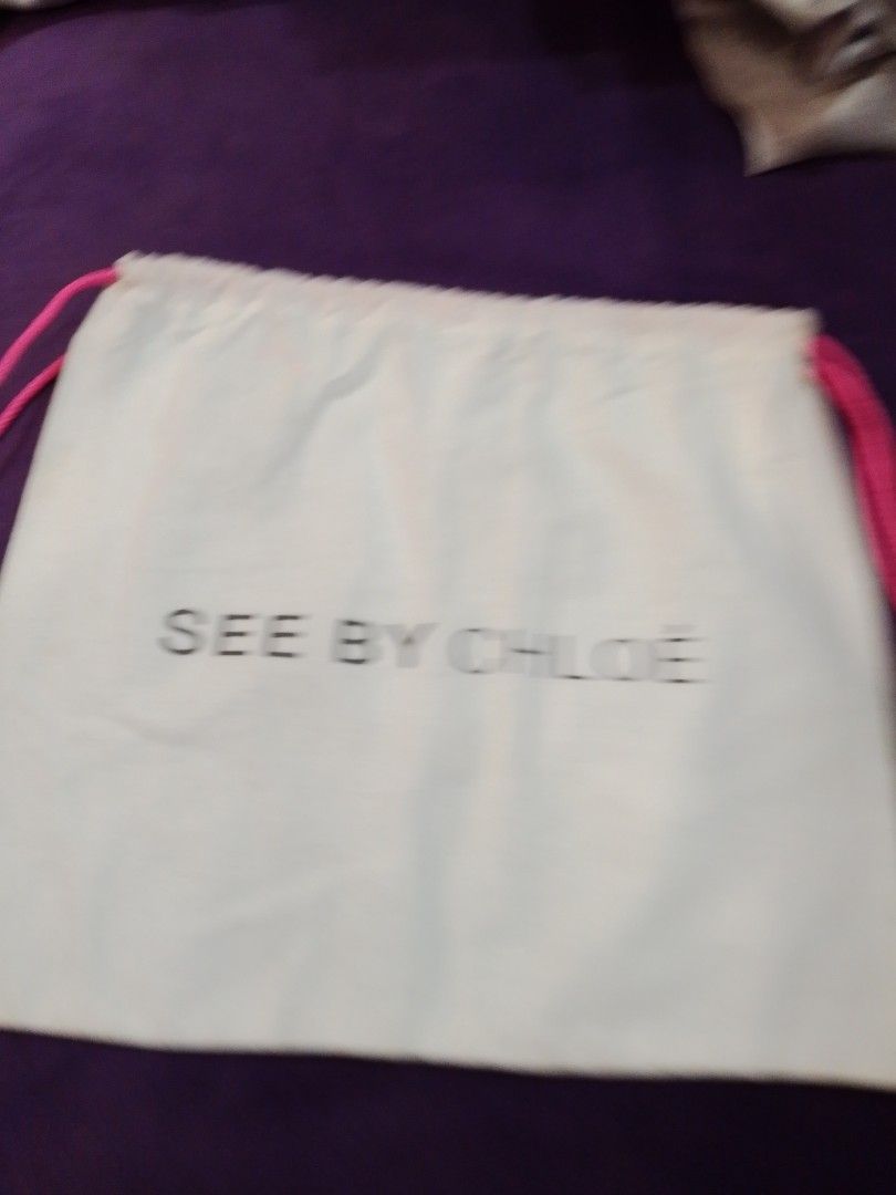 See by Chloé Dust Bag (Category: Luxury Bags & Wallets) located in Cabanatuan. Submitted by miss.maia (Listing ID 1419761008, Image 1). Description: - Authentic See by Chloé dust bag - White fabric - Black brand logo - Drawstring closure with pink cords - Approximately 11 inches in length - Perfect for protecting your See by Chloé bag.