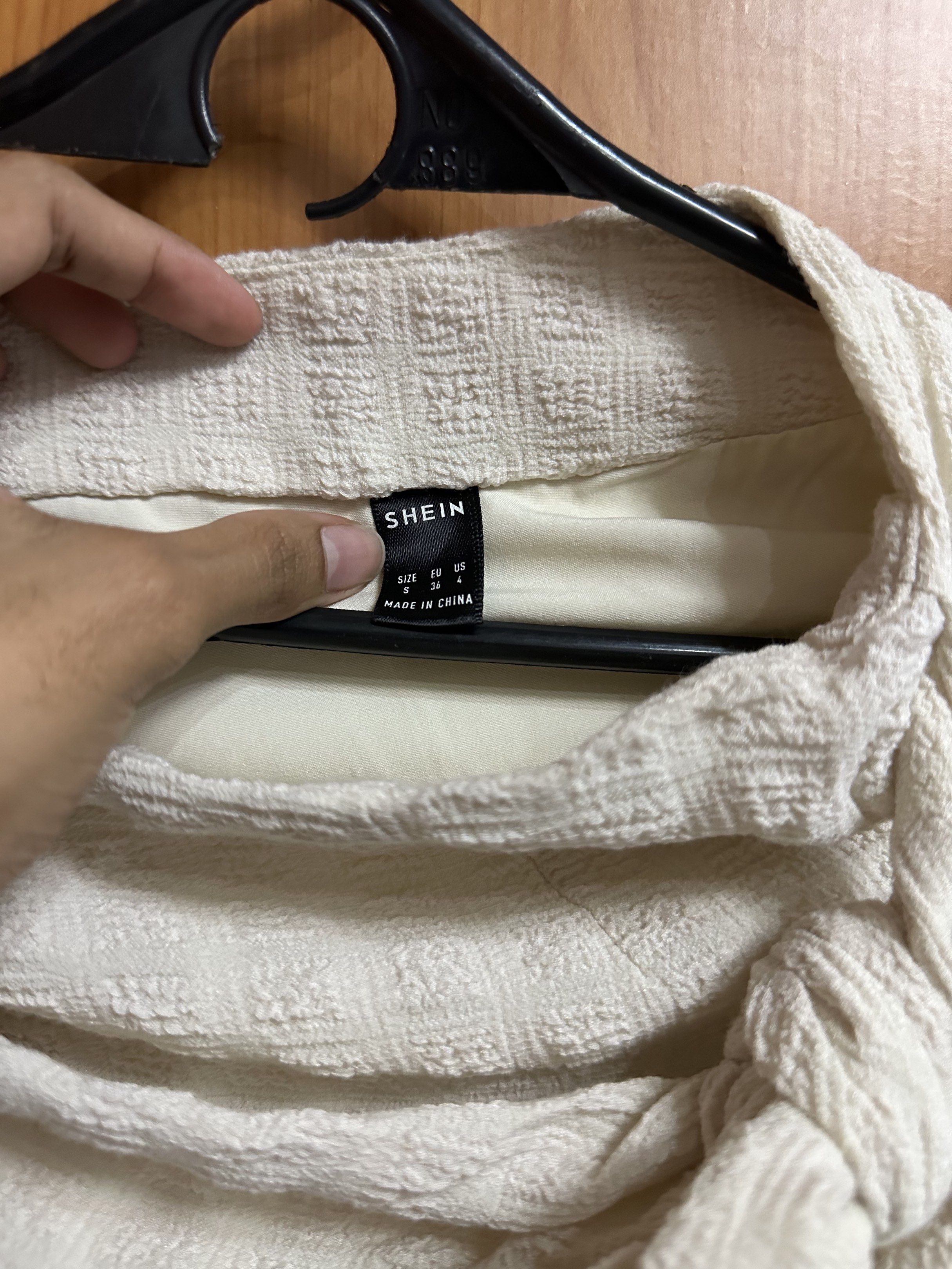SHEIN Wrap Skirt (Category: Skirts) located in Manila. Submitted by ryryrys (Listing ID 1419629588, Image 2). Description: - SHEIN cream-colored wrap skirt - Size: S - Features textured fabric - Tie closure - Versatile for casual wear.