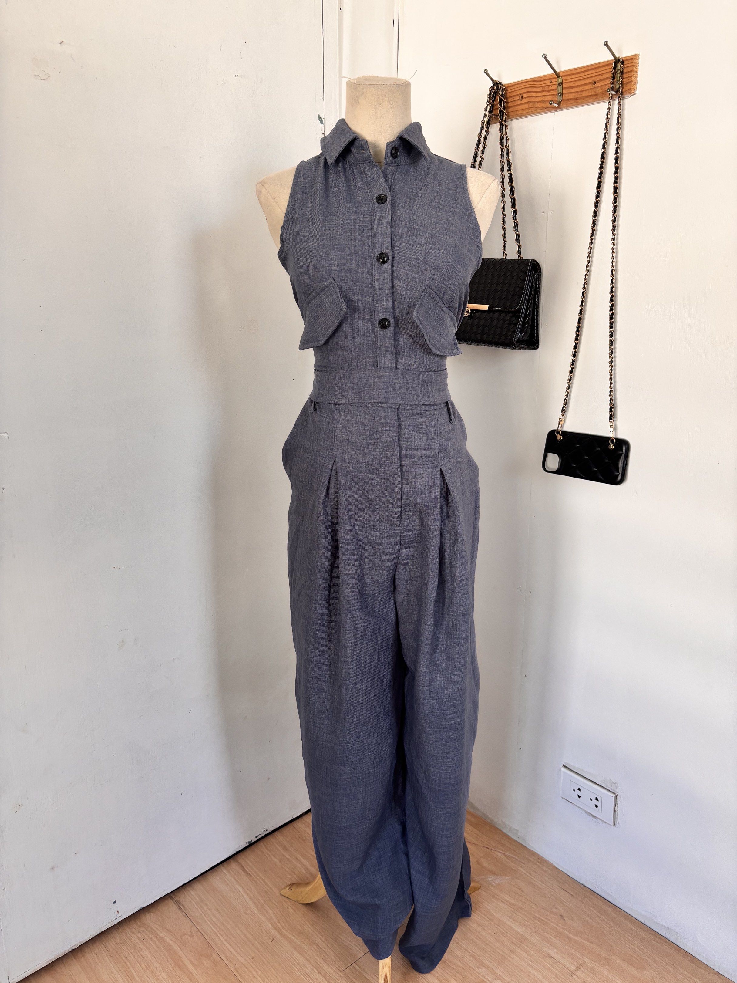 Sleeveless Jumpsuit with Belt (Category: Jumpsuits) located in Legazpi City. Submitted by sherrysph (Listing ID 1419644670, Image 2). Description: - Sleeveless jumpsuit in a muted blue-grey color. - Features a collared neckline and button-down front. - Includes two chest pockets. - Comes with a matching belt to cinch the waist. - Designed with a wide-leg for a comfortable and flattering fit. - Perfect for a chic and effortless look..