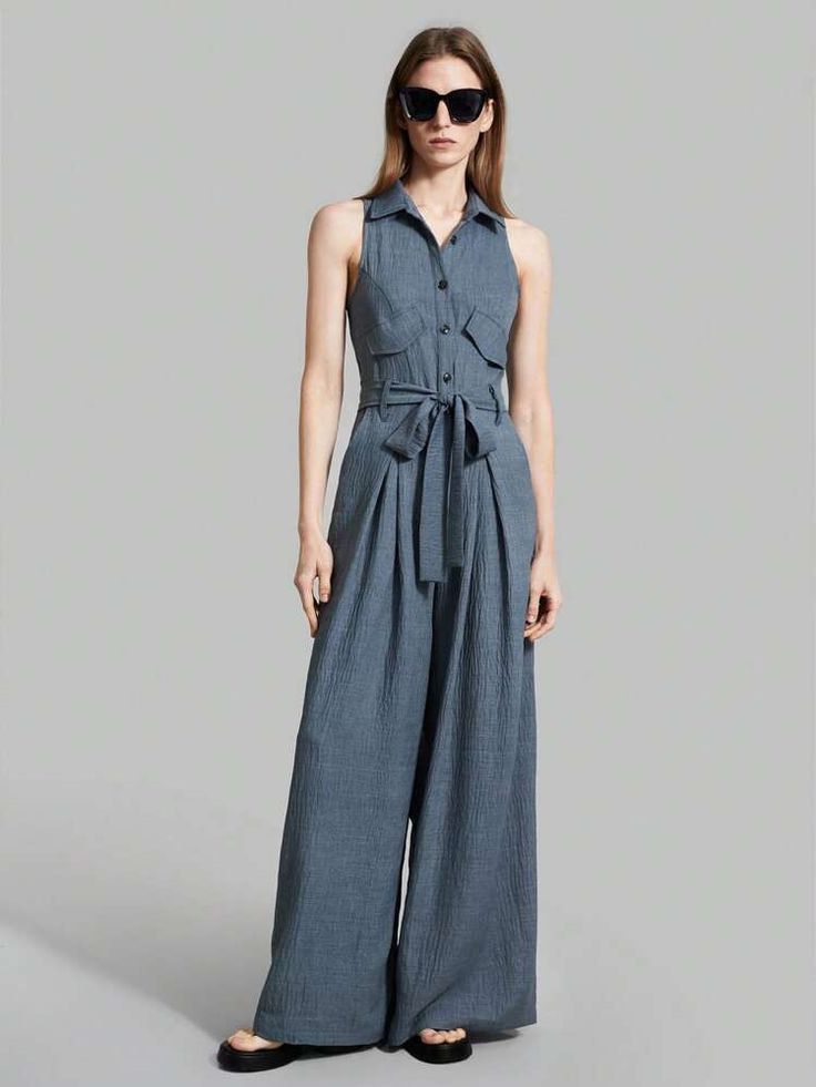 Sleeveless Jumpsuit with Belt (Category: Jumpsuits) located in Legazpi City. Submitted by sherrysph (Listing ID 1419644670, Image 1). Description: - Sleeveless jumpsuit in a muted blue-grey color. - Features a collared neckline and button-down front. - Includes two chest pockets. - Comes with a matching belt to cinch the waist. - Designed with a wide-leg for a comfortable and flattering fit. - Perfect for a chic and effortless look..