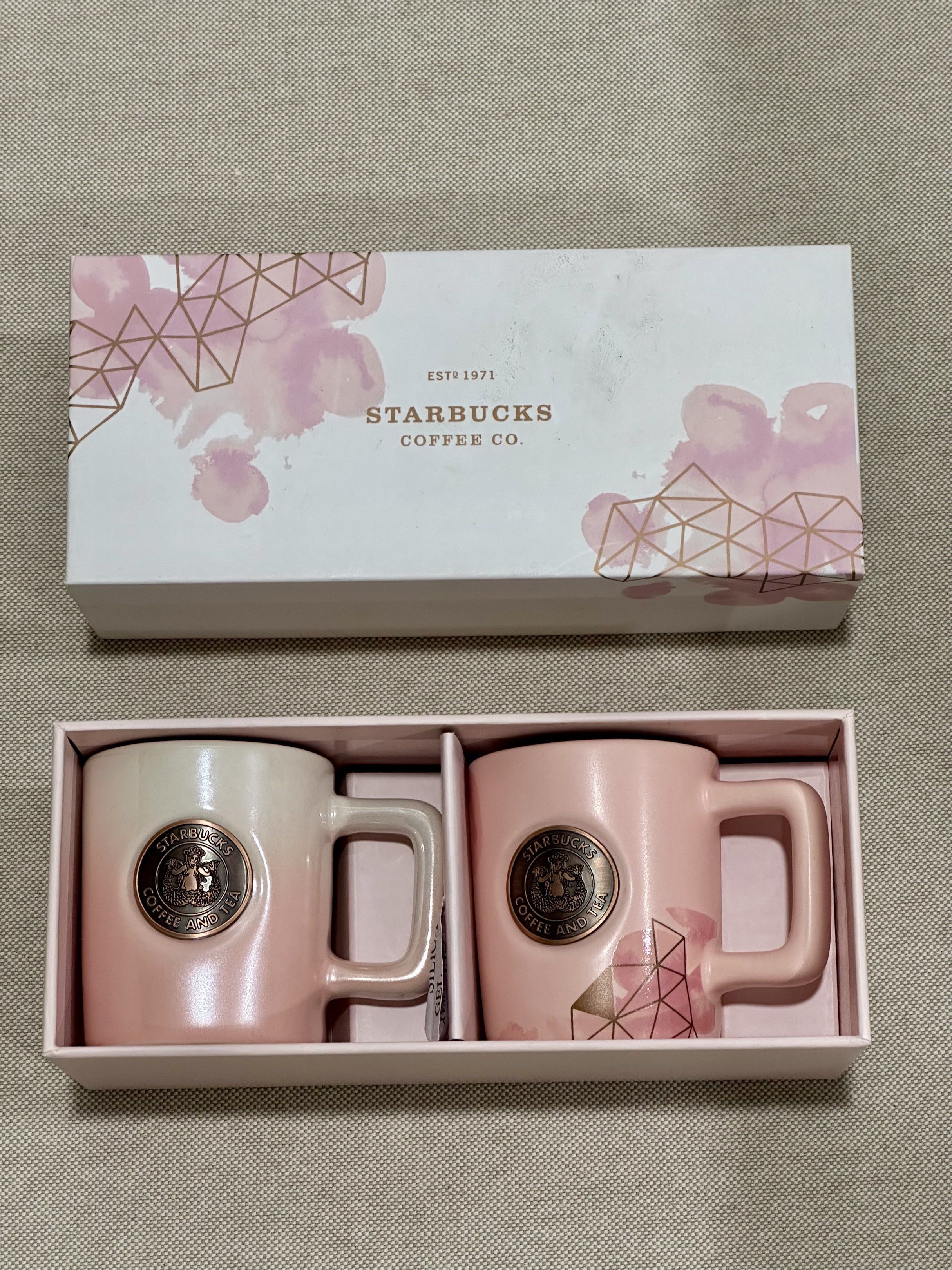 Starbucks Pink Demitasse Mug Set (Category: Coffee & Tea Tableware) located in Makati City. Submitted by sachi323 (Listing ID 1419769205, Image 1). Description: - Starbucks demitasse mug set - Includes two pink mugs - Features Starbucks logo - Comes in a floral gift box.