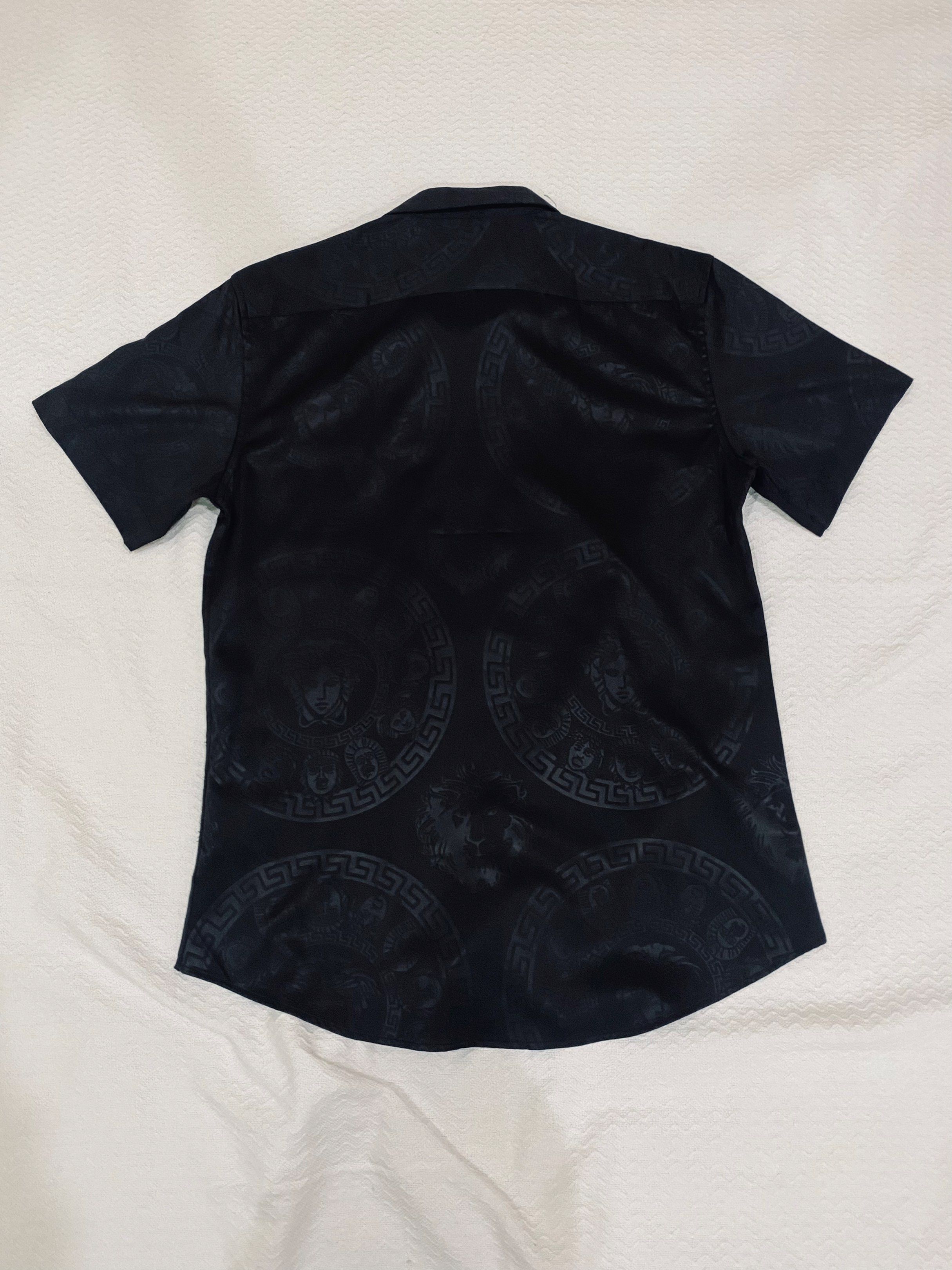 Versace Black Short Sleeve Shirt (Category: Tshirts & Polo Shirts ) located in Morong. Submitted by aa.vinmy (Listing ID 1419603865, Image 2). Description: Versace short sleeve shirt. Size M. Black with subtle pattern and logo. Silky material..