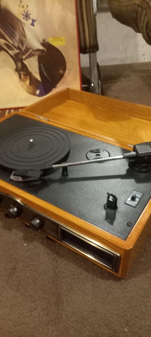 Vintage Record Player with Built-in Speakers (Category: Portable Music Players) located in Manila. Submitted by richardlee51903 (Listing ID 1419756989, Image 2). Description: - Vintage record player - Wooden cabinet - Built-in speakers - Turntable and tonearm included - Volume and other controls - Subwoofer line out - DC 9V input - Includes a record album - Perfect for listening to vinyl records.