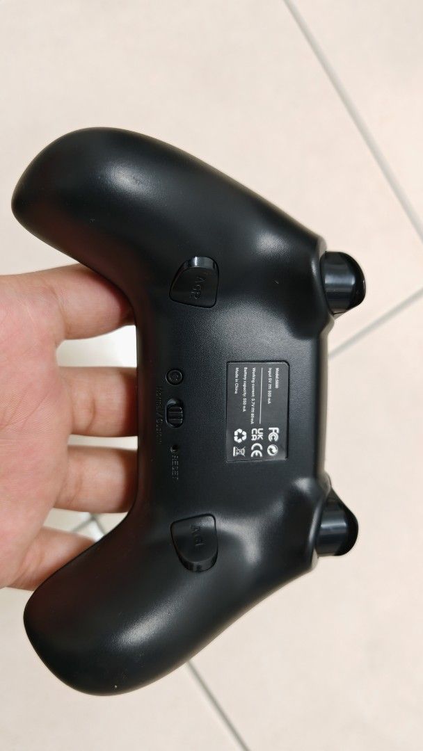 Wireless Controller (Category: Controllers) located in Sungai Buloh. Submitted by shirou99 (Listing ID 1419597347, Image 2). Description: - Wireless gaming controller - Black color - Standard button layout (directional pad, analog sticks, action buttons) - Features a charging port - Additional function buttons on the back - Designed for comfortable handling -This is specially made for IOS (Iphone, mac, ipad, etc) -Android cannot connect. -Window 