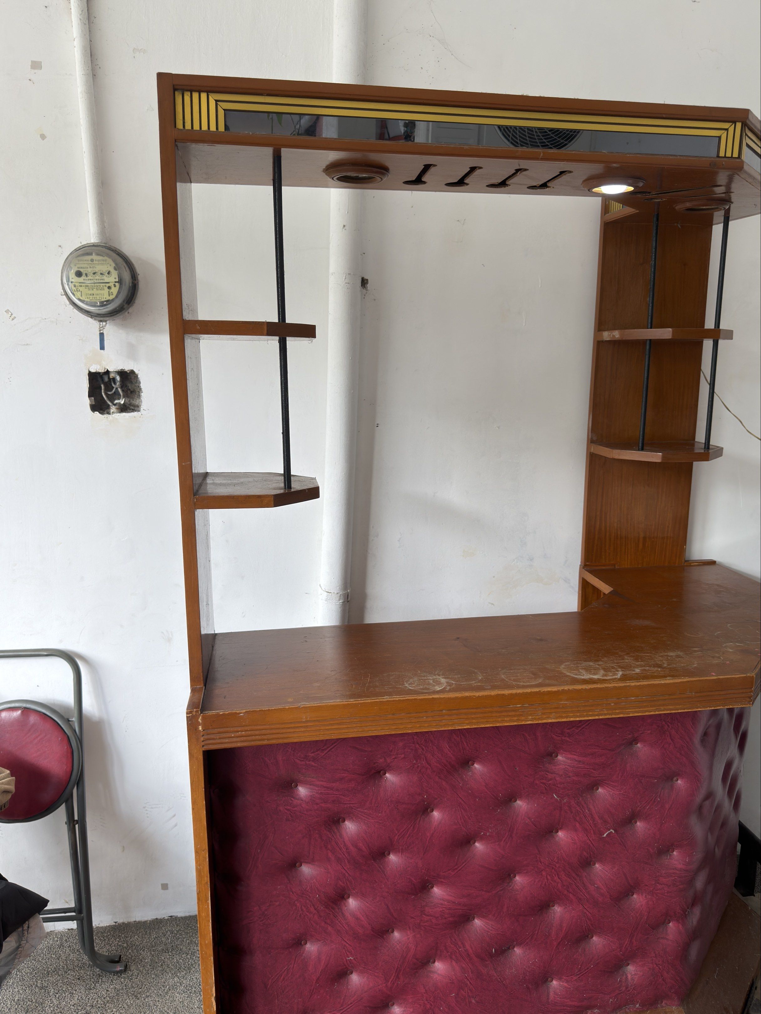 Wooden Bar with Shelves (Category: Shelves, Cabinets & Racks) located in Manila. Submitted by khaazzii11 (Listing ID 1419730047, Image 2). Description: - Wooden bar with multiple shelves - Built-in wine glass rack - Countertop included - Burgundy upholstered front - Built-in lighting - Unique corner design with side shelving - Perfect for home entertainment or small business use.