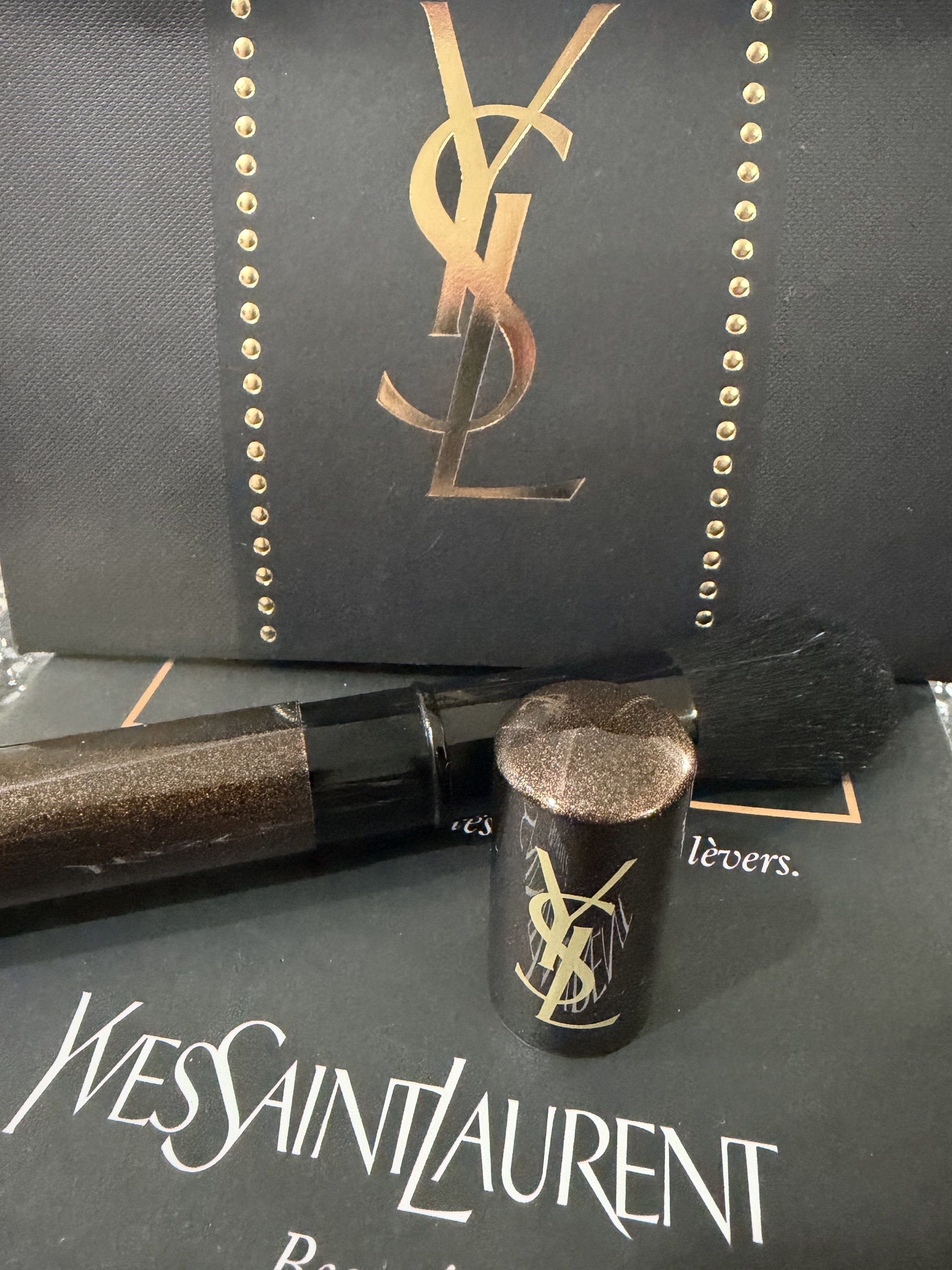 Yves Saint Laurent Retractable Brush (Category: Makeup) located in Davao. Submitted by gr8stmom_melissa (Listing ID 1419627901, Image 1). Description: - Yves Saint Laurent retractable makeup brush - Features a metallic brown handle - Black brush head - Authentic YSL logo visible - Comes with a protective cap.