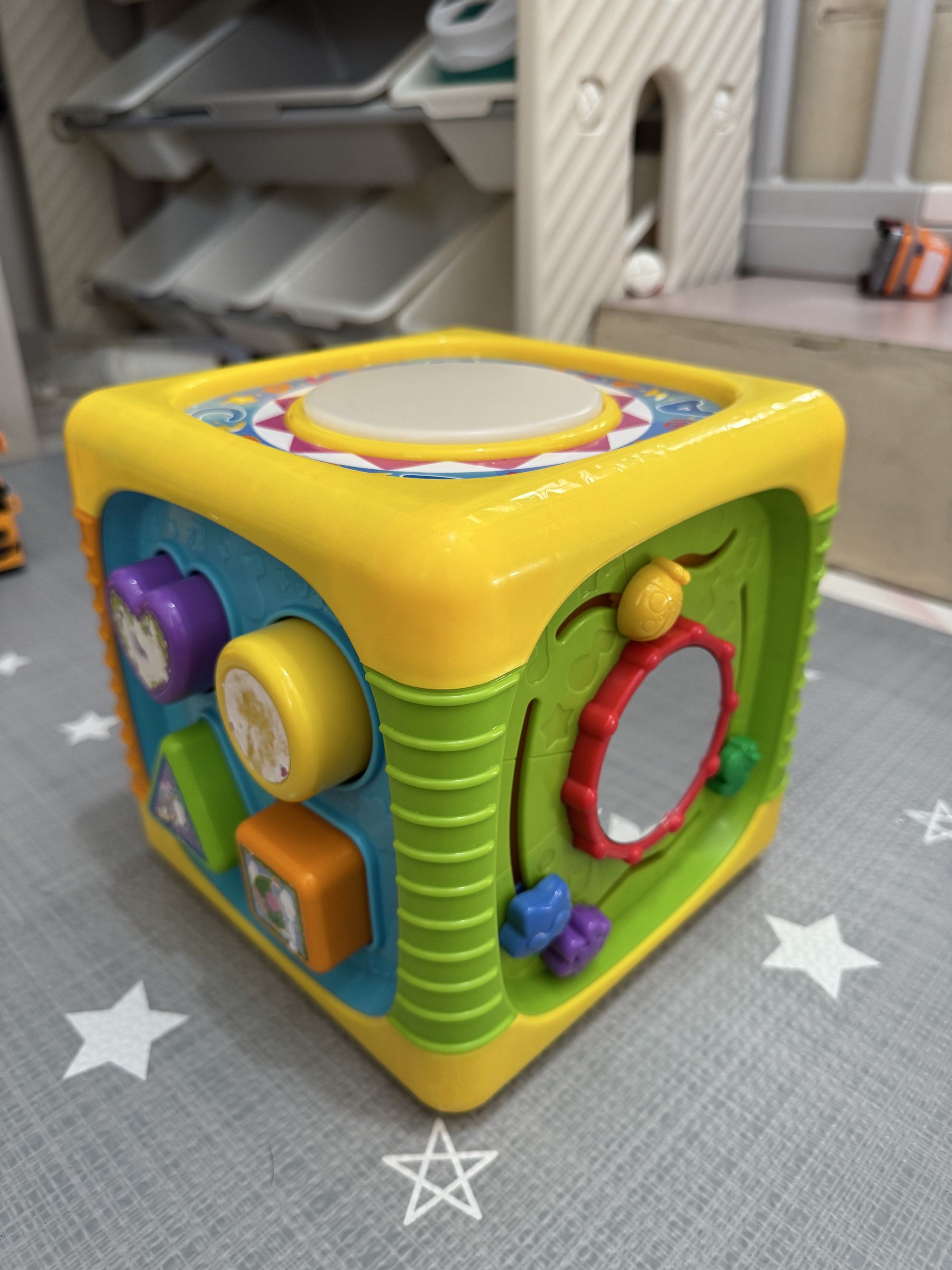 Activity Busy Cube Toy (Category: Infant Playtime) located in Bacoor. Submitted by darklab_project (Listing ID 1419896116, Image 2). Description: Bought this for P2500 - Interactive activity cube for toddlers. - Includes a drum, gears, shape sorter, and mirror. - Features a piano with musical notes. - Designed with bright, engaging colors. - Multiple buttons and shapes for interactive play..