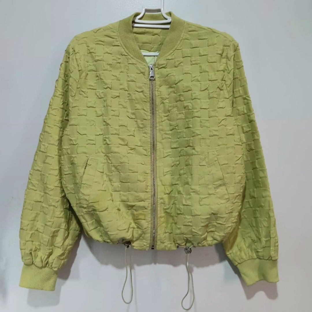 Apple Green Textured Bomber Jacket (Category: Coats, Jackets and Outerwear) located in Quezon City. Submitted by hapyllein (Listing ID 1419879662, Image 1). Description: - Unique texture 🫶🏻 - Ribbed collar & cuffs - Drawstring hem Shoulder: 12" Width: 17" Length: 16: Shoulders: 18" note: color may slightly vary due to lighting..