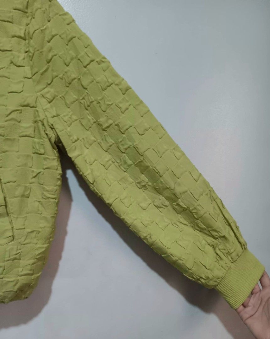 Apple Green Textured Bomber Jacket (Category: Coats, Jackets and Outerwear) located in Quezon City. Submitted by hapyllein (Listing ID 1419879662, Image 2). Description: - Unique texture 🫶🏻 - Ribbed collar & cuffs - Drawstring hem Shoulder: 12" Width: 17" Length: 16: Shoulders: 18" note: color may slightly vary due to lighting..