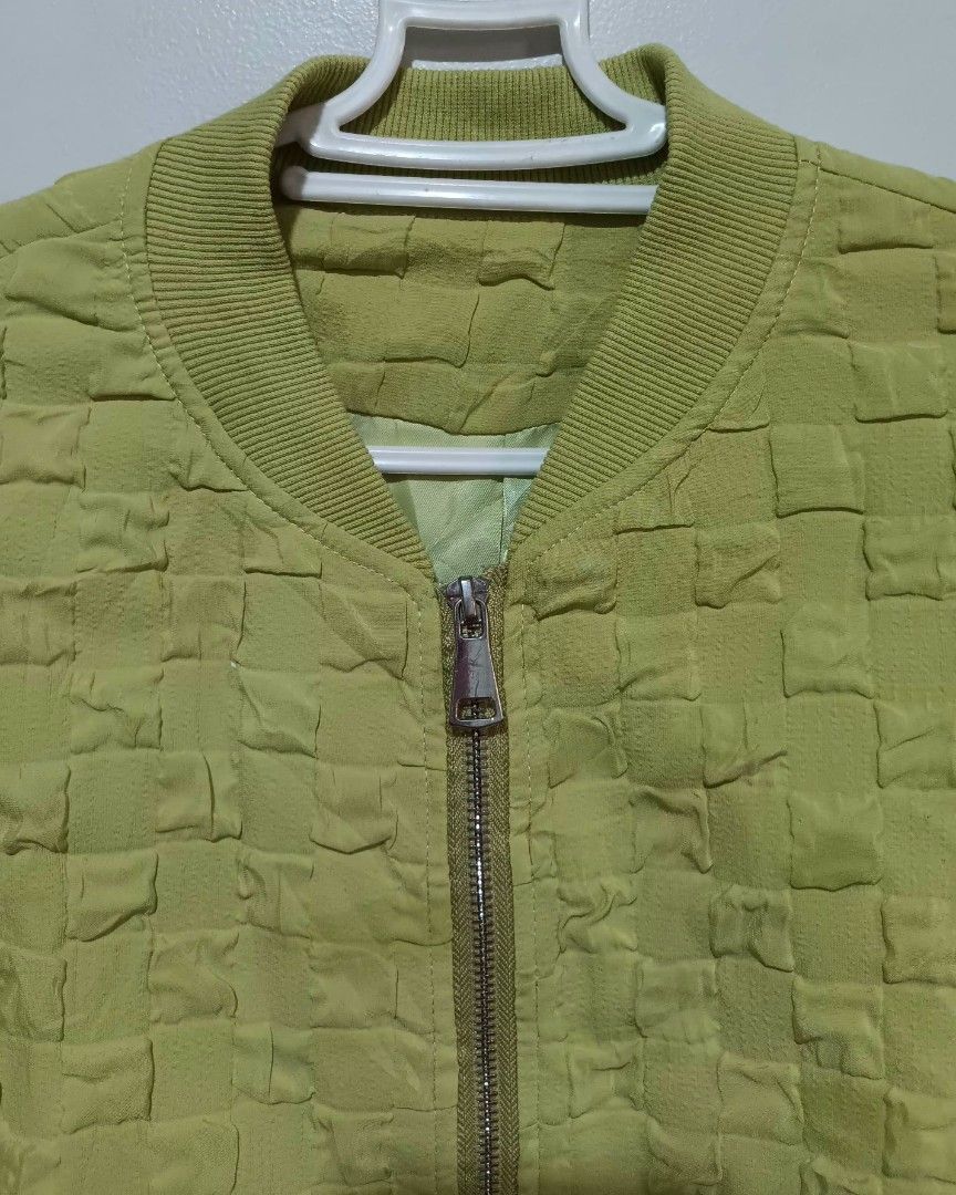 Apple Green Textured Bomber Jacket (Category: Coats, Jackets and Outerwear) located in Quezon City. Submitted by hapyllein (Listing ID 1419879662, Image 3). Description: - Unique texture 🫶🏻 - Ribbed collar & cuffs - Drawstring hem Shoulder: 12" Width: 17" Length: 16: Shoulders: 18" note: color may slightly vary due to lighting..