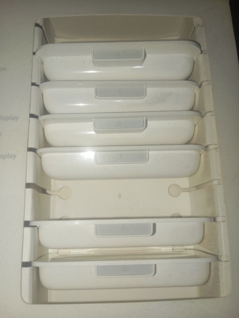 Apple iPod Remote with 6 Different iPod unit adapter (Category: Portable Music Players) located in Pasig City. Submitted by live_cosmicstorm (Listing ID 1419866274, Image 2). Description: Includes the Apple iPod remote, dock, and six white accessories. The remote is white and has a circular control pad. The accessories are in individual white cases. The original box is included, which is black with the Apple logo. The box also contains a white in