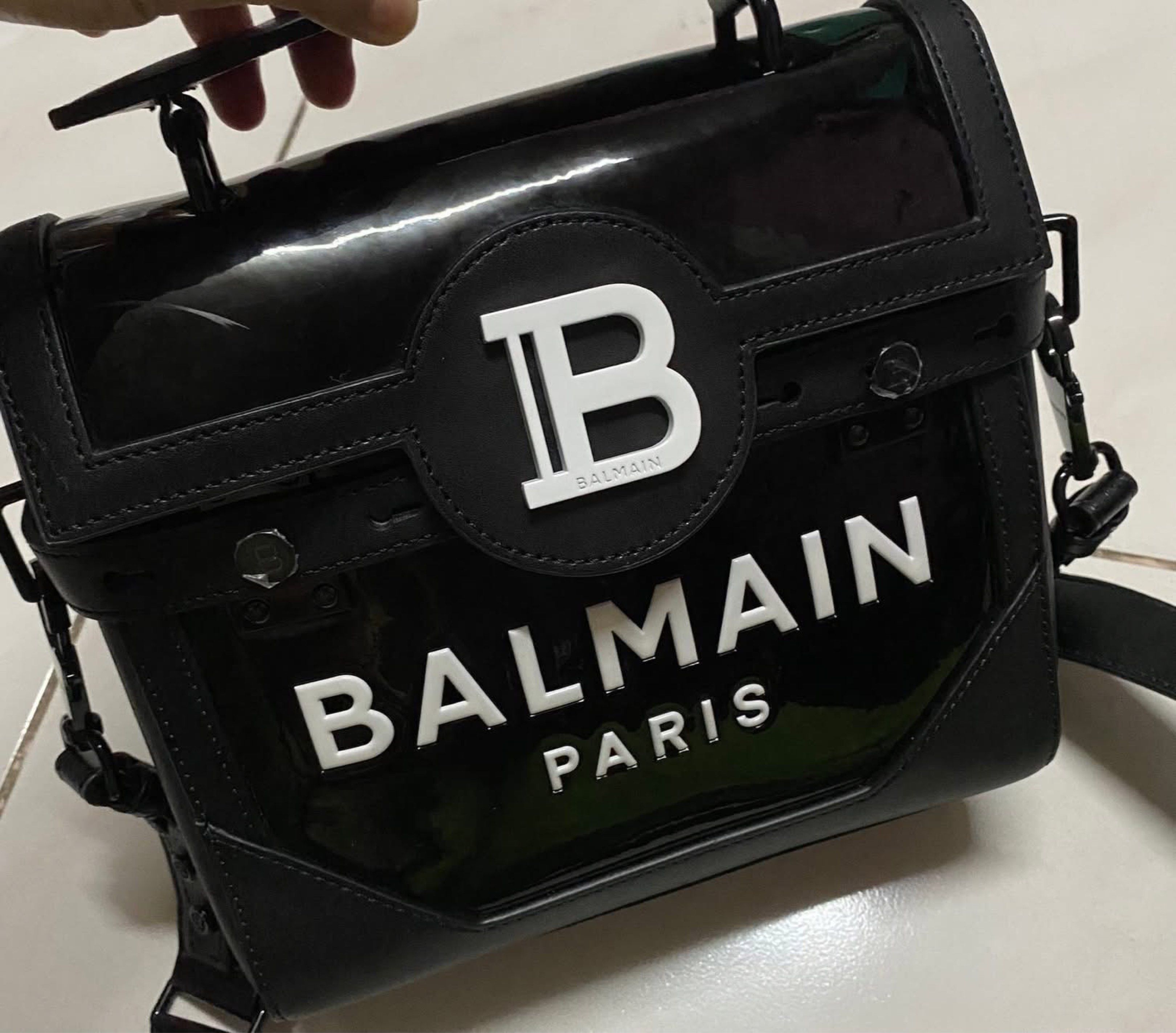 Balmain Paris 2-way top handle bag (Category: Luxury Bags & Wallets) located in Muntinlupa City. Submitted by prelovedbrandedgoodies (Listing ID 1419915846, Image 2). Description: - Balmain Paris handbag - Black color - Top handle - Detachable shoulder strap - Glossy finish - Balmain logo on front - Interior with Balmain logo and "Made in Italy" inscription.