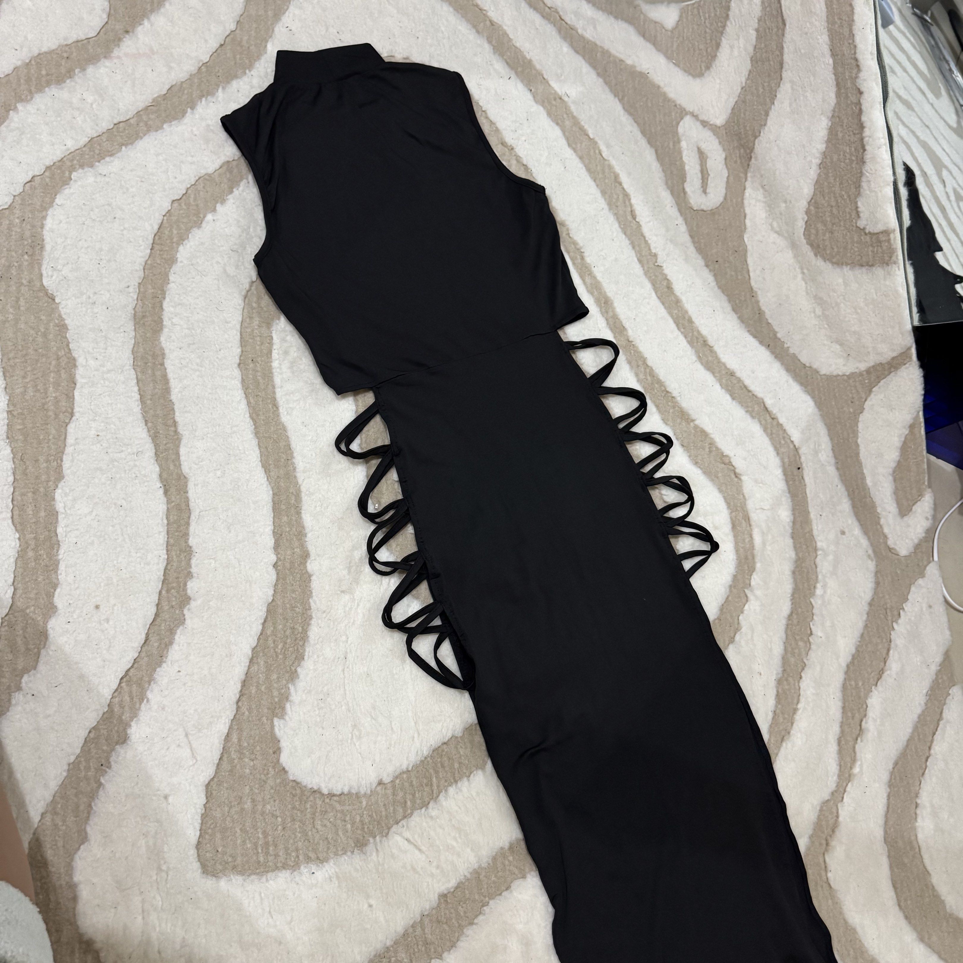 Black Cutout Maxi Dress (Category: Dresses) located in Makati City. Submitted by finders.keep.hers (Listing ID 1419842459, Image 1). Description: - Sleeveless black maxi dress - High neckline - Cutout detailing on sides - Made of stretchy material - Fitted silhouette - Ideal for nights out and special occasions.