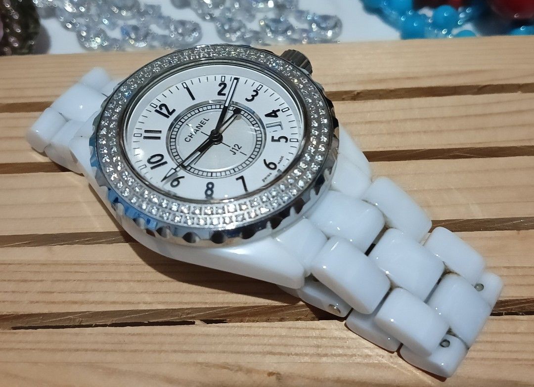 Chanel J12 Diamond Bezel White Ceramic Watch (Category: Luxury Watches) located in Baguio. Submitted by khailyjhotheatro18 (Listing ID 1419921279, Image 2). Description: - Chanel J12 watch - White ceramic bracelet and case - Diamond-encrusted bezel - White dial with black hands and numerals - Date display at 3 o'clock - Butterfly clasp - Marked with Chanel Paris on the back.