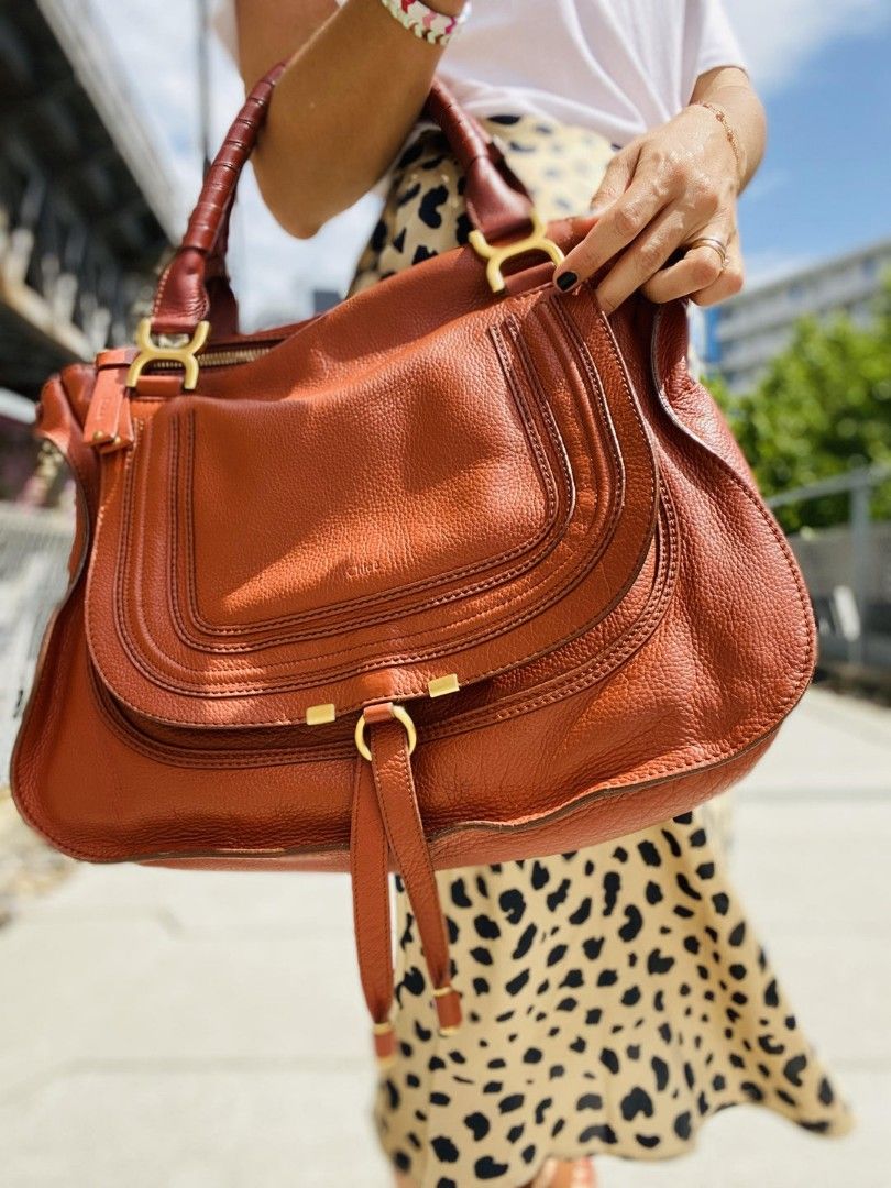 Chloe Marcie Leather Handbag (Category: Luxury Bags & Wallets) located in Quezon City. Submitted by emerson.lachica (Listing ID 1419816212, Image 1). Description: - Chloe Marcie handbag - Color: Brown - Features: - Top handle - Detachable shoulder strap - Flap closure with tassel - Includes Chloe tags - Interior lining: Black - Gold-tone hardware - Chloe logo embossed on leather.