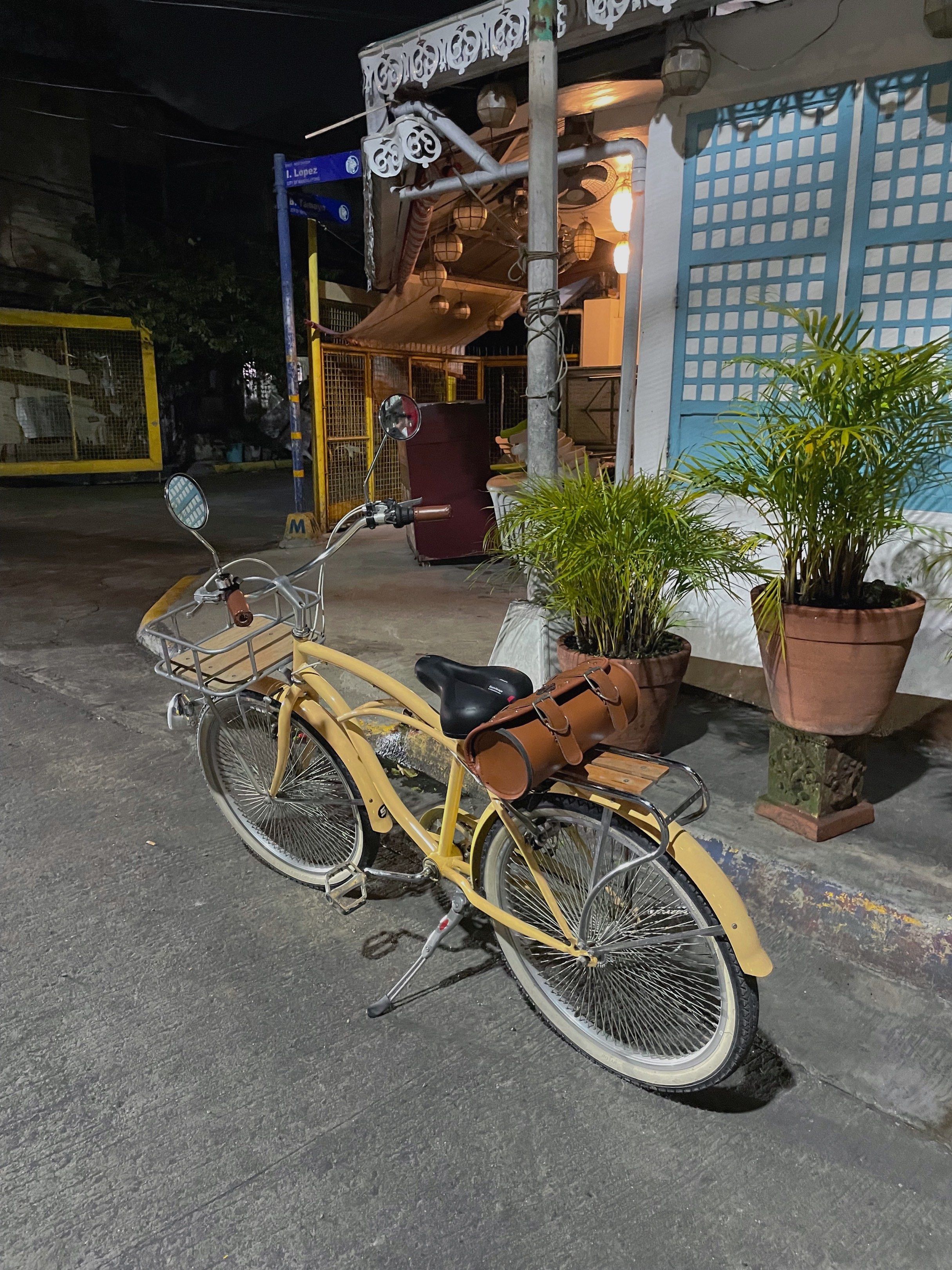 Custom Cruiser Bike with Accessories (Category: Bicycles) located in Manila. Submitted by ragssurplus (Listing ID 1419784127, Image 2). Description: - Custom cruiser bike with a unique design - Cream-colored frame - White-walled tires - Wooden basket - Custom leather bag with Harley-Davidson logo - Comfortable black seat - Brown leather grips - Perfect for leisurely rides.