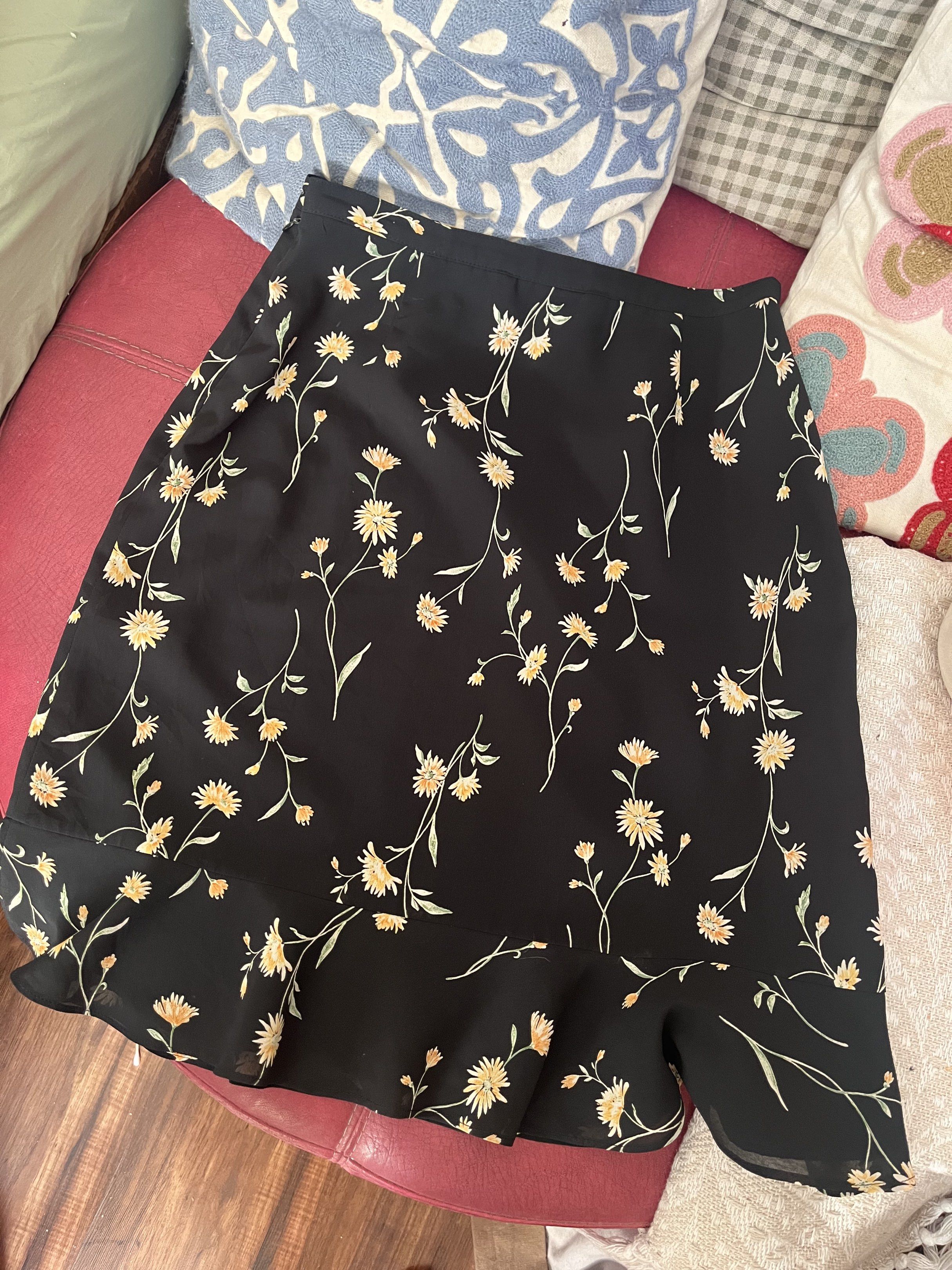 Floral Black Midi Skirt (Category: Skirts) located in Manila. Submitted by betlovesmatcha (Listing ID 1419859970, Image 1). Description: - Floral print midi skirt - Features a ruffled hem - Side slit detail - Made of lightweight material - A-line silhouette - Suitable for warm weather - Versatile for casual or dressed-up outfits.