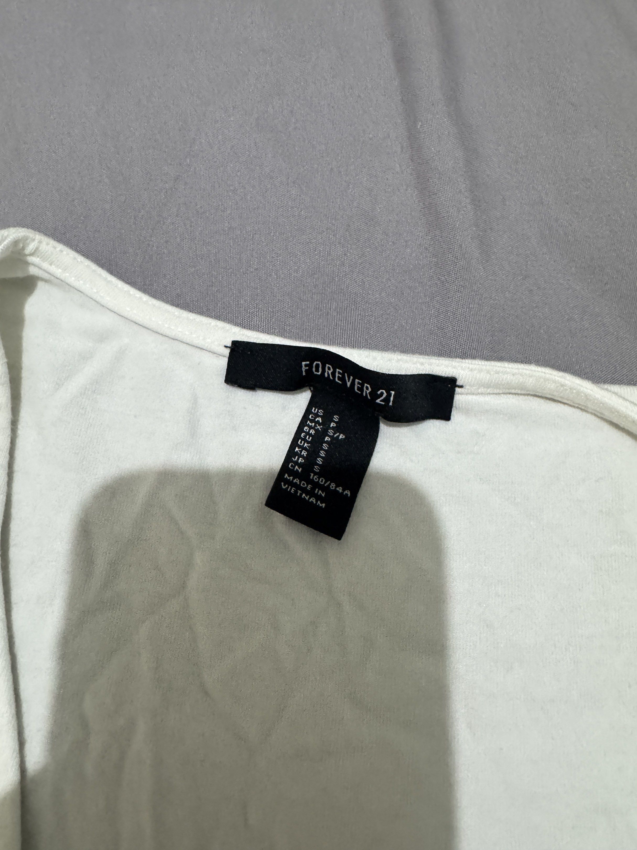 Forever 21 Wrap Top - White and Black (Category: Blouses) located in Pasig City. Submitted by caaex (Listing ID 1419940872, Image 3). Description: - Forever 21 wrap tops - Colors: White (Size S) and Black (Size M) - Features: V-neck, short sleeves - Made in Vietnam.