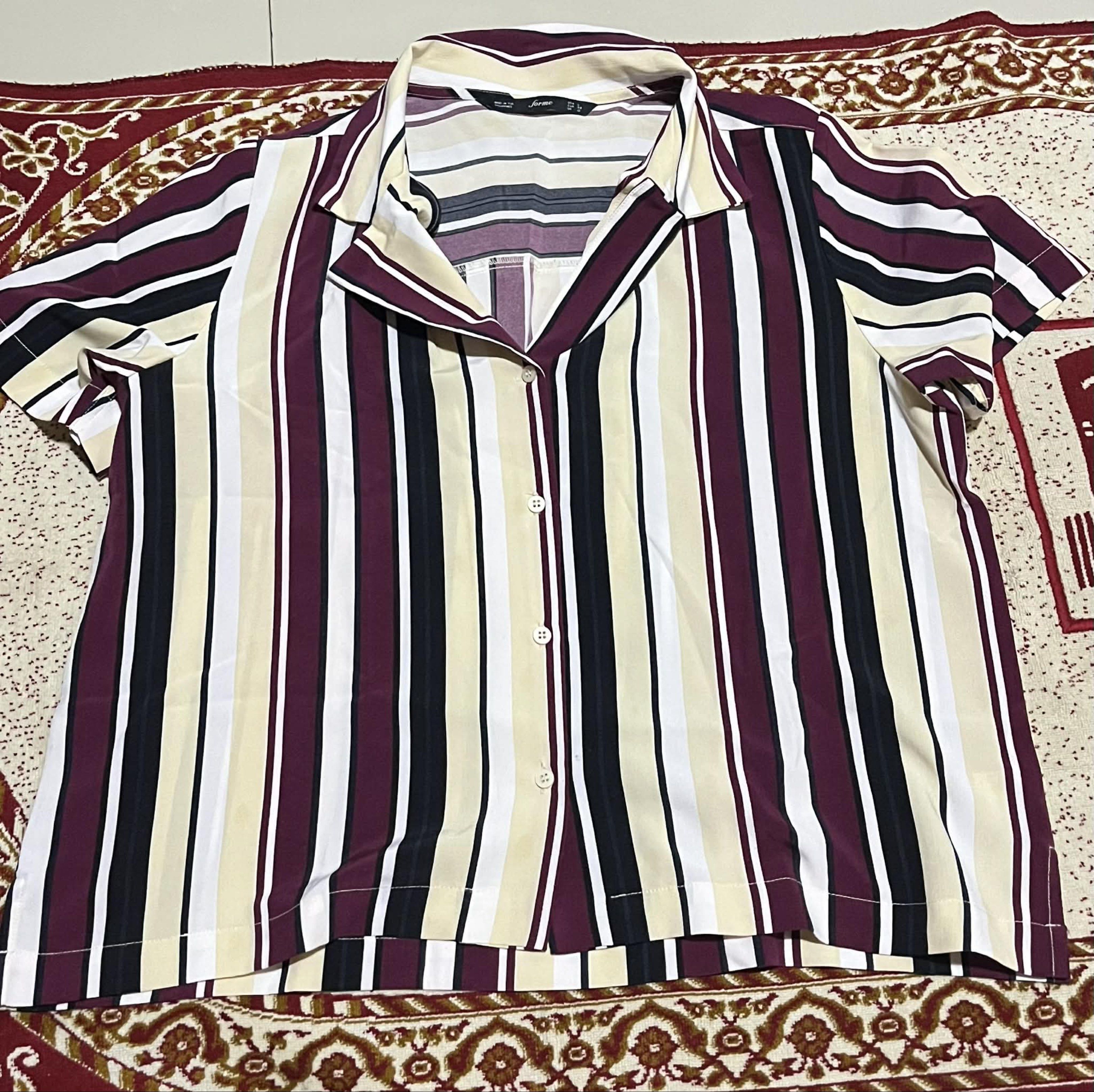 Forme Striped Button-Down Top (Category: Blouses) located in Bacolod City. Submitted by james_andrei (Listing ID 1419961174, Image 3). Description: Price 150 Forme button-down shirt - Size: L (Can fit to M) - Color: Burgundy, black, cream, and white vertical stripes - Features: Short sleeves, classic collar Condition: Used once only Flaws: N/A RFS: Decluttering Mode of Payment: GCash, Bank transfer Mode of Shipping: Jnt Express (SF shouldered by 