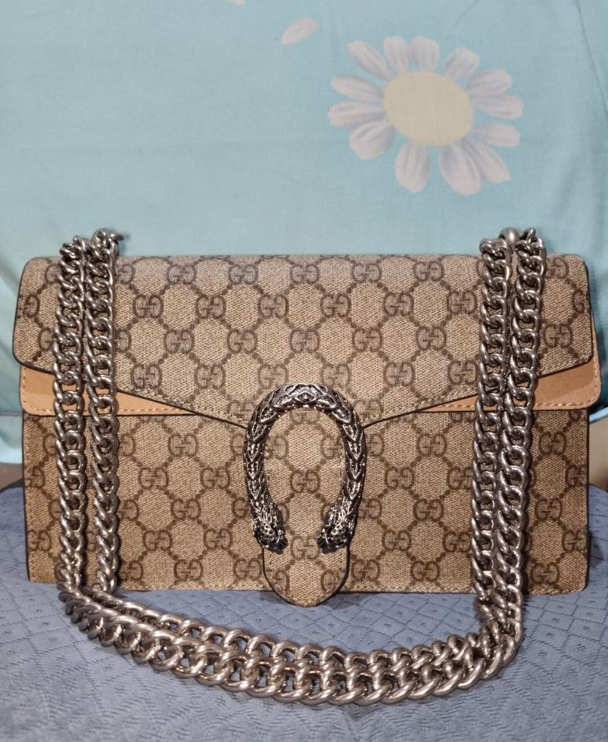Gucci Dionysus Shoulder Bag (Category: Luxury Bags & Wallets) located in San Juan City. Submitted by cheryl20624 (Listing ID 1419816542, Image 1). Description: - Auth Gucci Dionysus bag - Iconic GG Supreme canvas - Silver-tone chain strap - Signature tiger head closure - Beige leather trim - Spacious interior - Perfect for any occasion.
