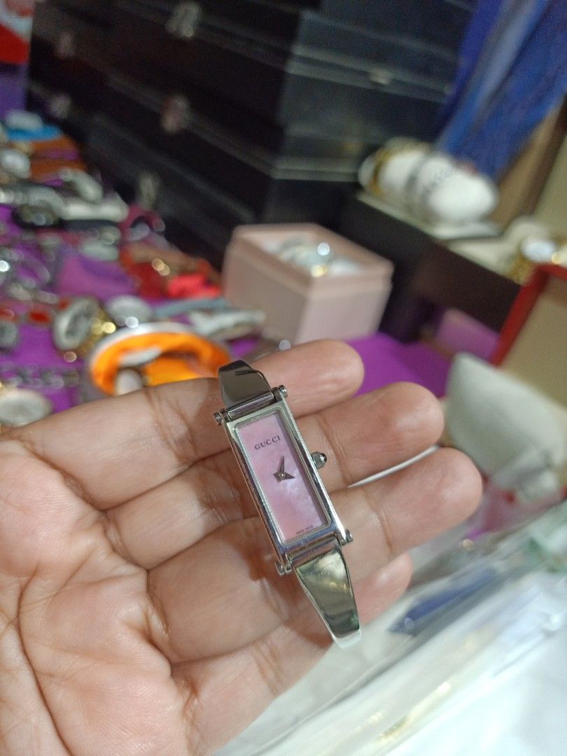Gucci Ladies Watch (Category: Luxury Watches) located in Cagayan de Oro. Submitted by mmmdshop (Listing ID 1419858686, Image 1). Description: - Gucci ladies watch - Rectangular pink dial - Silver-tone bracelet it's preloved in good working - Gucci buckle design - Minimalist design - Suitable for everyday wear or special occasions - Adds a touch of luxury.