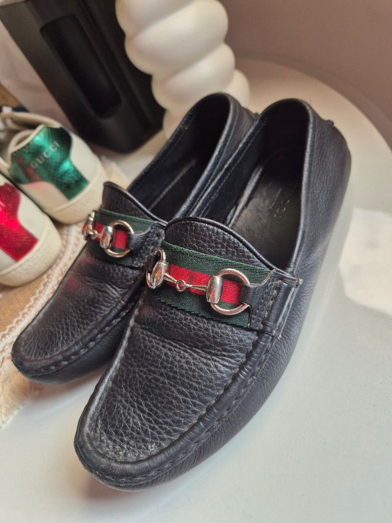 Gucci Leather Loafers with web details (Category: Loafers) located in Manila. Submitted by jamdr66227 (Listing ID 1419813553, Image 1). Description: - Genuine Gucci loafers - Black leather - Green and red web detail - Silver hardware - Gucci logo on soles - Classic design - Versatile for casual and semi-formal wear.