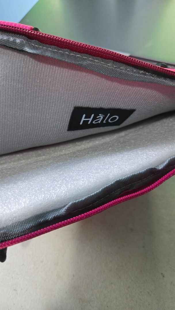 Halo Tablet Bag - Pink (Category: Laptop Bags & Sleeves) located in San Mateo. Submitted by realmeljorie (Listing ID 1419844550, Image 3). Description: - Pink tablet bag - Size: 10"x8" - Zippered main compartment - Front zippered pocket - Adjustable straps and handle - 'Halo' logo - Padded interior for protection - Made of durable, textured material.
