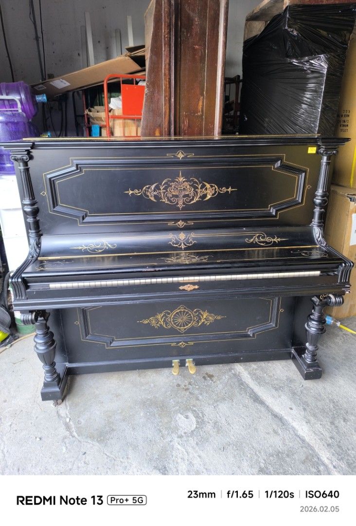 Hoflieferant Piano - Black (Category: Musical Instruments) located in Dasmarinas. Submitted by bossgabo (Listing ID 1419852826, Image 2). Description: - Elegant black piano - Full keyboard with white and black keys - Decorative gold accents - Classic design with ornate legs and detailing - Features two pedals.