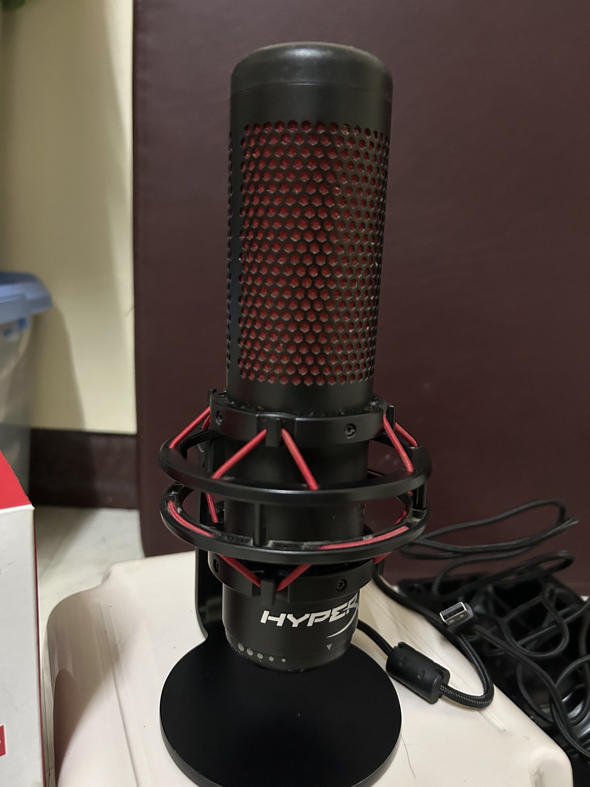 HyperX QuadCast USB Microphone (Category: Microphones) located in Manila. Submitted by mndz.08 (Listing ID 1419906645, Image 3). Description: - HyperX QuadCast USB microphone - Includes original box and accessories - Stylish red and black design - Compatible with PC, PS4, and Mac - Features anti-vibration shock mount - Tap-to-mute functionality.