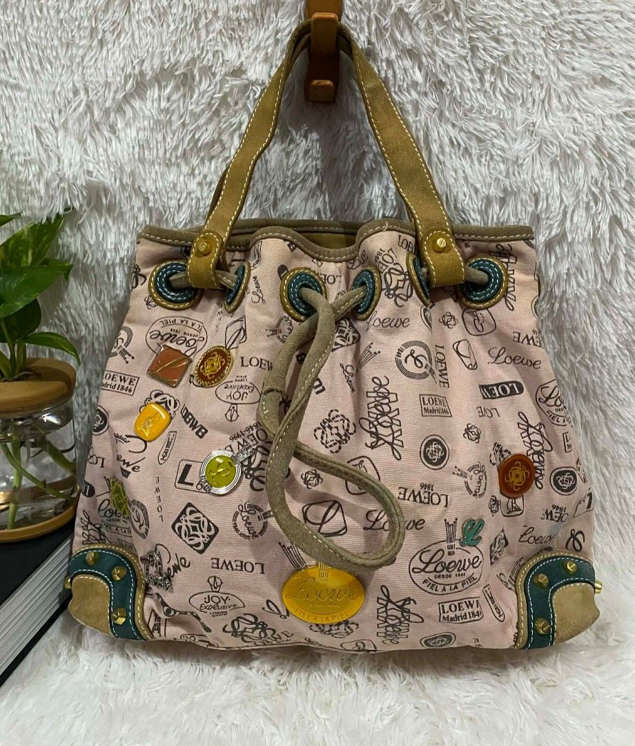 Loewe Pink Canvas Handbag (Category: Luxury Bags & Wallets) located in Manila. Submitted by gutierrez23265 (Listing ID 1410241773, Image 3). Description: - Vintage Loewe bucket handbag - Pink canvas material - Drawstring closure - Leather handles - Features Loewe logos and decorative patches - Dark fabric lining - Interior zipper closure - Studded base with leather accents PLS CHECK ALL PHOTOS DETAILS BEFORE MAGMINE NO RETURN NO EXCHANGE PAYMENT 