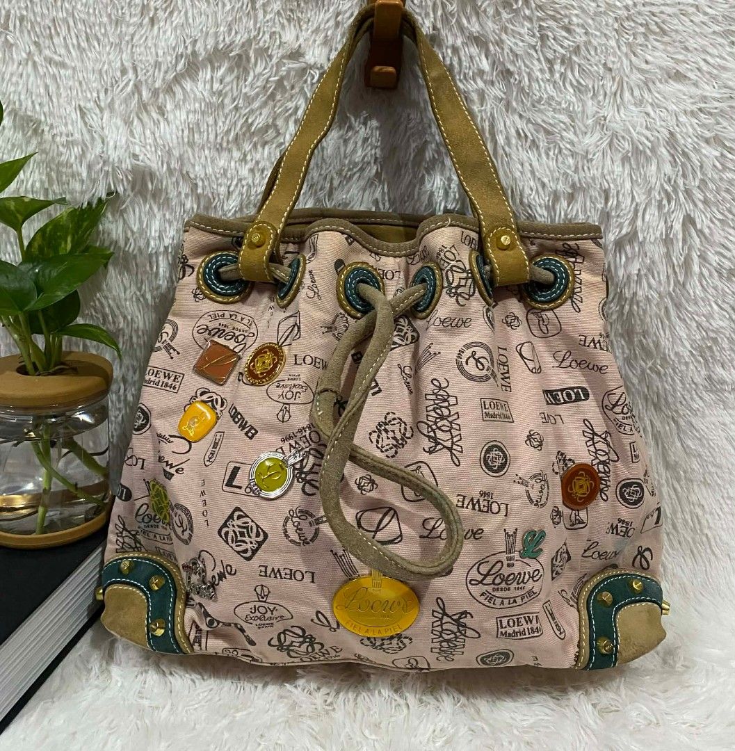 Loewe Pink Canvas Handbag (Category: Luxury Bags & Wallets) located in Manila. Submitted by gutierrez23265 (Listing ID 1410241773, Image 1). Description: - Vintage Loewe bucket handbag - Pink canvas material - Drawstring closure - Leather handles - Features Loewe logos and decorative patches - Dark fabric lining - Interior zipper closure - Studded base with leather accents PLS CHECK ALL PHOTOS DETAILS BEFORE MAGMINE NO RETURN NO EXCHANGE PAYMENT 