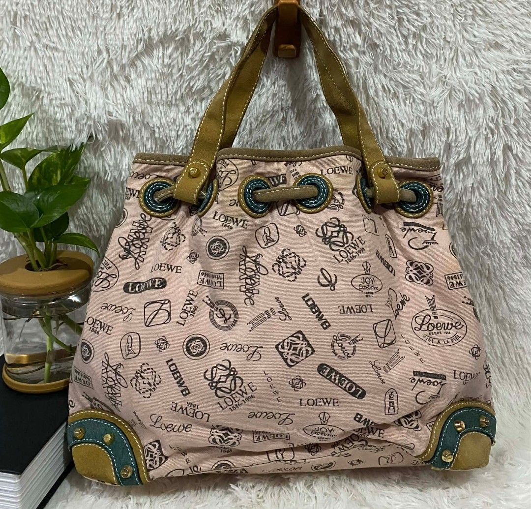 Loewe Pink Canvas Handbag (Category: Luxury Bags & Wallets) located in Manila. Submitted by gutierrez23265 (Listing ID 1410241773, Image 2). Description: - Vintage Loewe bucket handbag - Pink canvas material - Drawstring closure - Leather handles - Features Loewe logos and decorative patches - Dark fabric lining - Interior zipper closure - Studded base with leather accents PLS CHECK ALL PHOTOS DETAILS BEFORE MAGMINE NO RETURN NO EXCHANGE PAYMENT 
