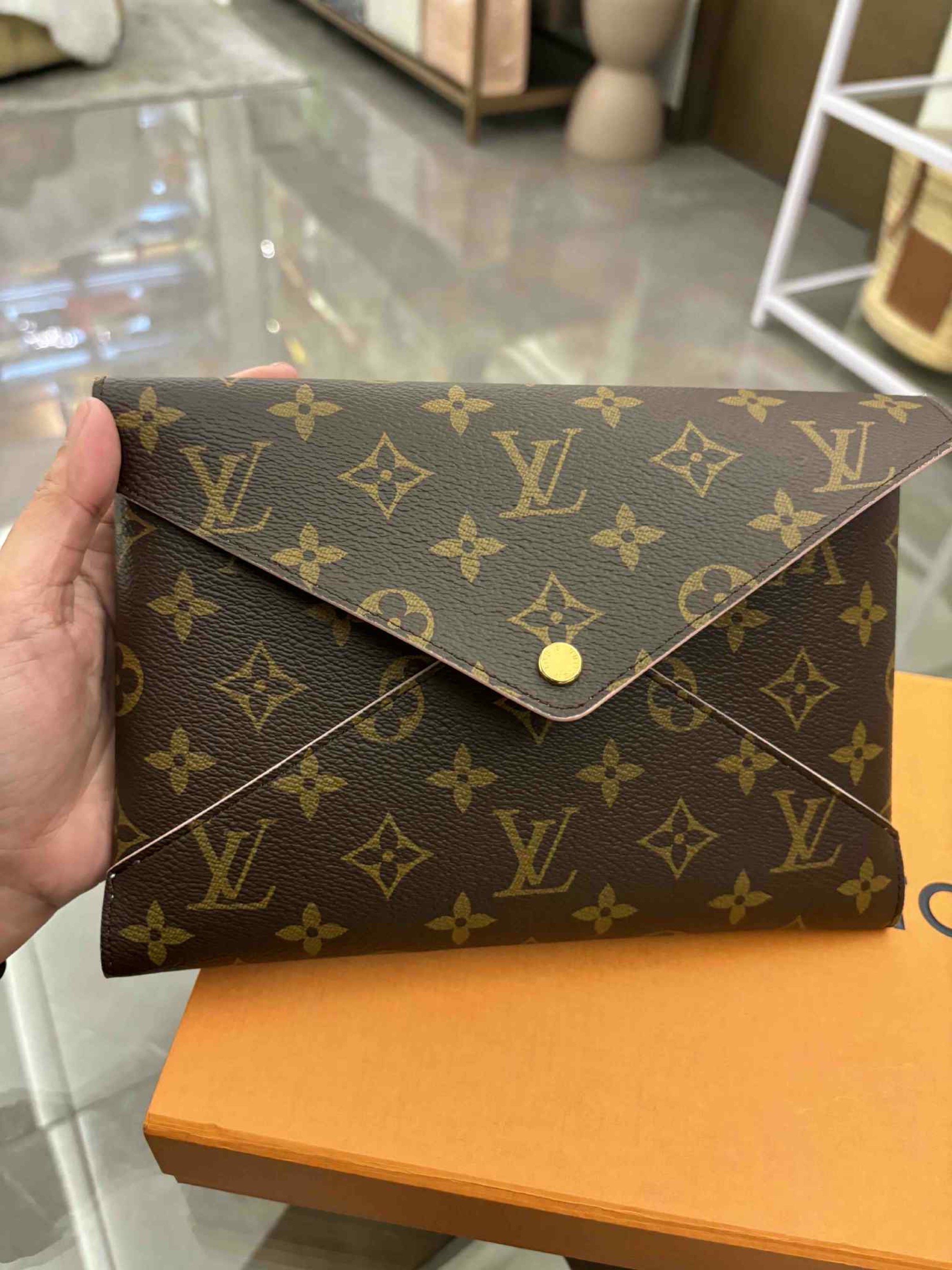 Louis Vuitton Kirigami Envelope Pouch (Category: Luxury Bags & Wallets) located in Makati City. Submitted by vanessacaeg_ (Listing ID 1419878418, Image 1). Description: RFS: Decluttering Like New/Unused, so might as well pass them on to someone who will - Authentic Louis Vuitton clutch - Iconic monogram pattern - Flap closure with gold-tone button - Light pink interior - Comes with original box, dust bag, and cards .