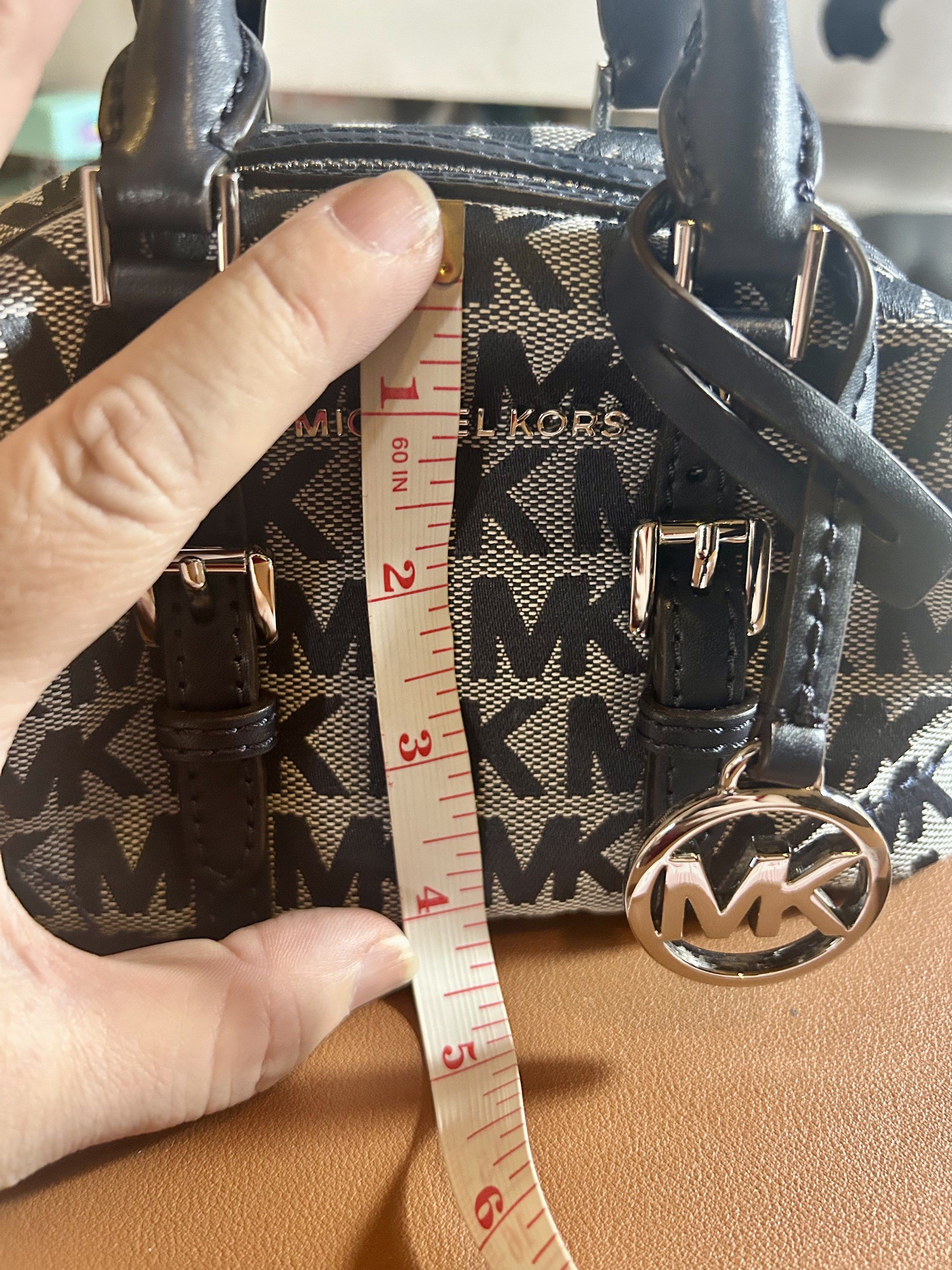 Michael Kors ginger xs mini duffle bag (Category: Luxury Bags & Wallets) located in Quezon City. Submitted by asiaco (Listing ID 1419823581, Image 3). Description: For those who are keen on tiny things like me, this is an Authentic Michael Kors ginger xs mini duffle bag. Features a navy blue and gray MK logo pattern. Includes a detachable shoulder strap and a top handle. The bag has silver hardware and an MK charm. The original price tag is inclu