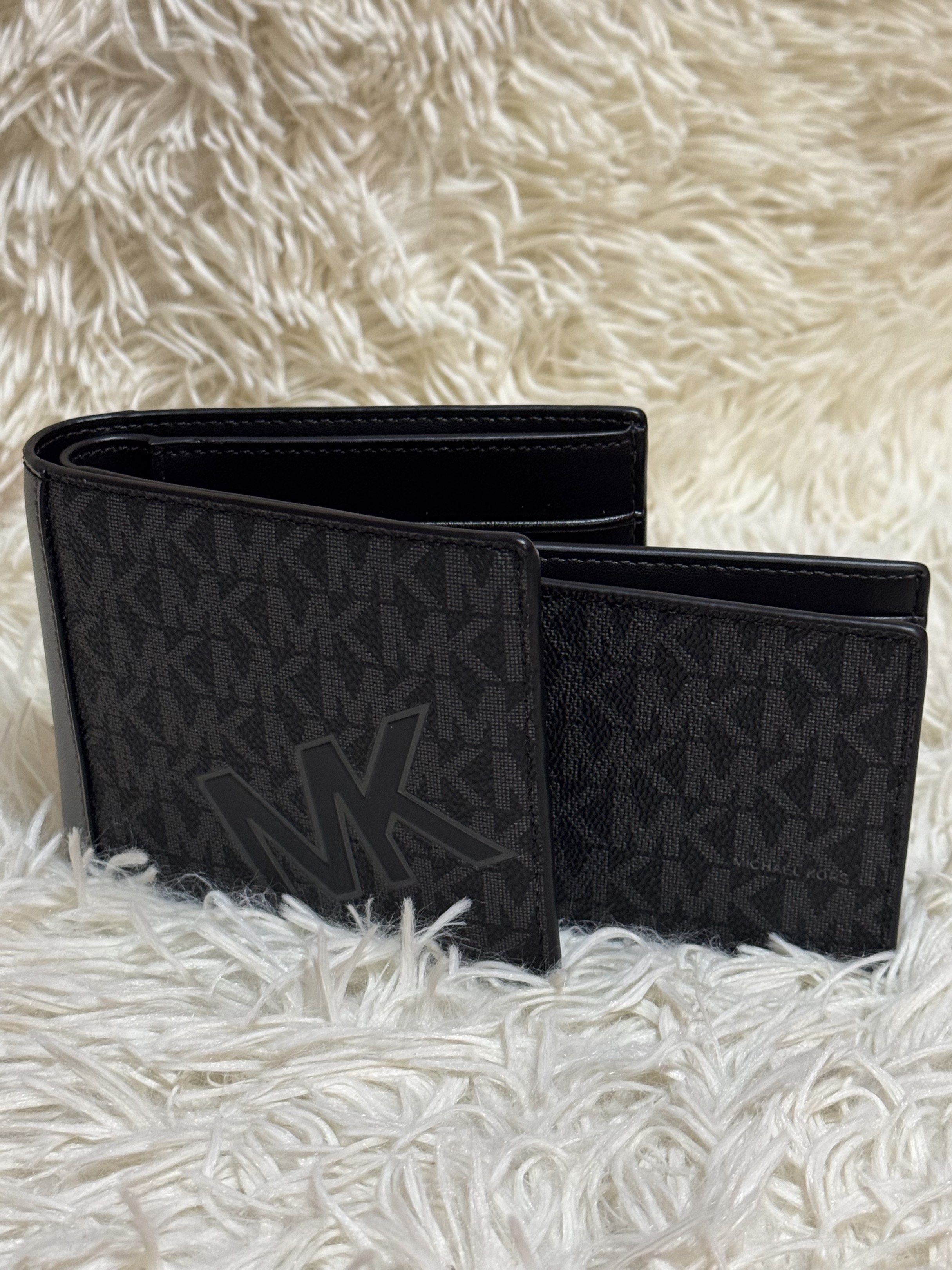 Michael Kors MK Logo Wallet Set (Category: Luxury Bags & Wallets) located in Rodriguez. Submitted by nancyb13 (Listing ID 1419875867, Image 2). Description: Set includes a bi-fold wallet and a cardholder, both featuring the iconic MK logo pattern. The bi-fold wallet has multiple card slots and a clear ID window. The cardholder is compact and designed for essential cards. Both items are black with the MK logo in a darker shade. The interior of the